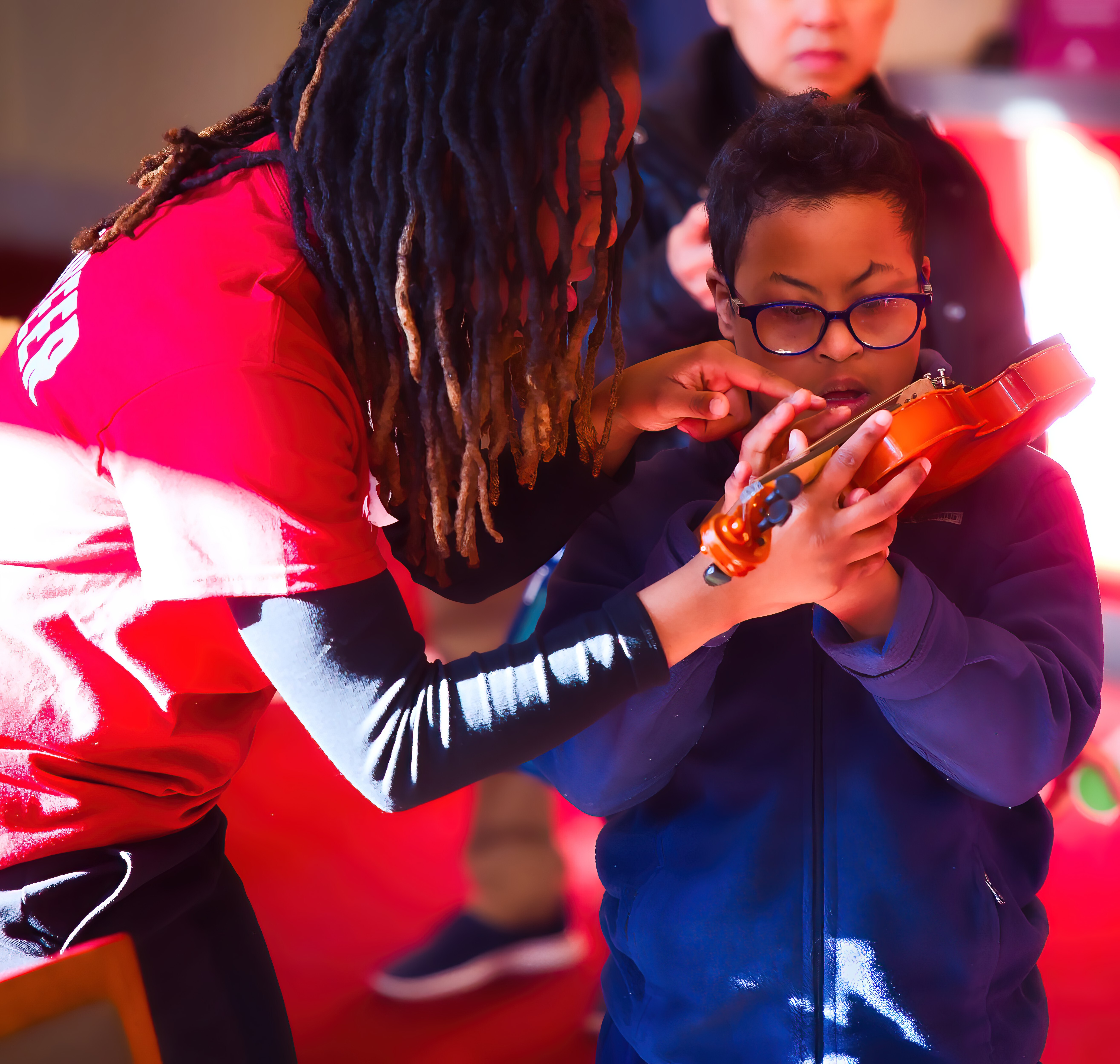 Volunteer with child at the Sensory Friendly instrument playground