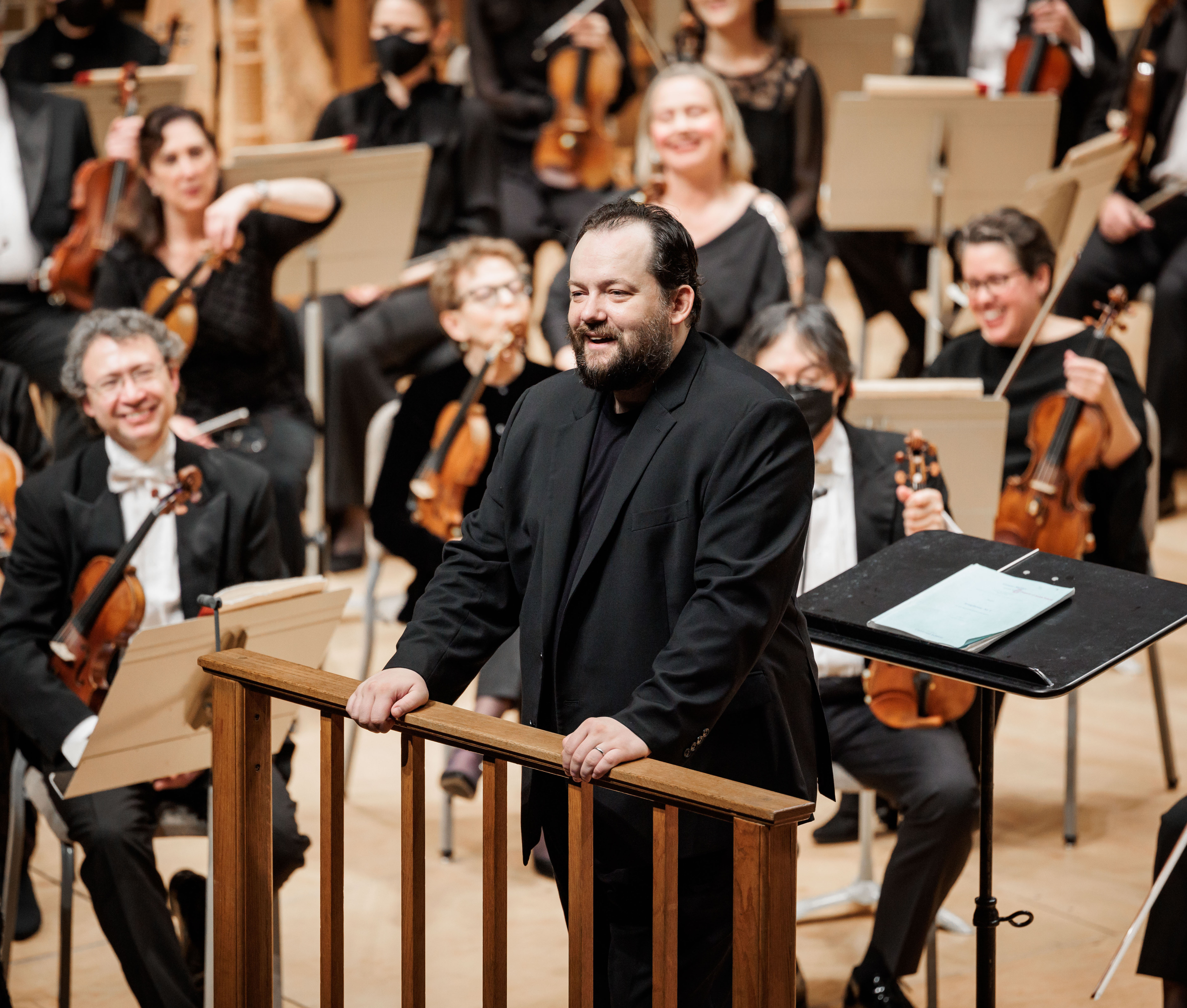 Andris Nelsons smiling and facing the audience in Symphony Hall