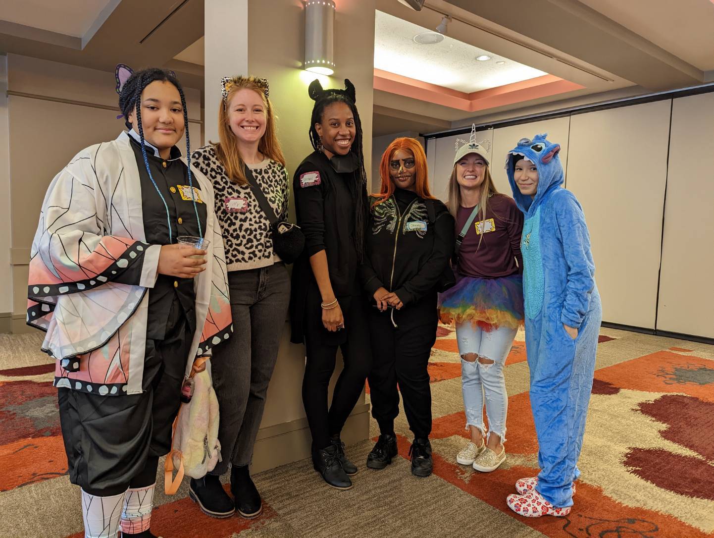 A group of big and little sisters from Big Sister in costume at mixer before concert