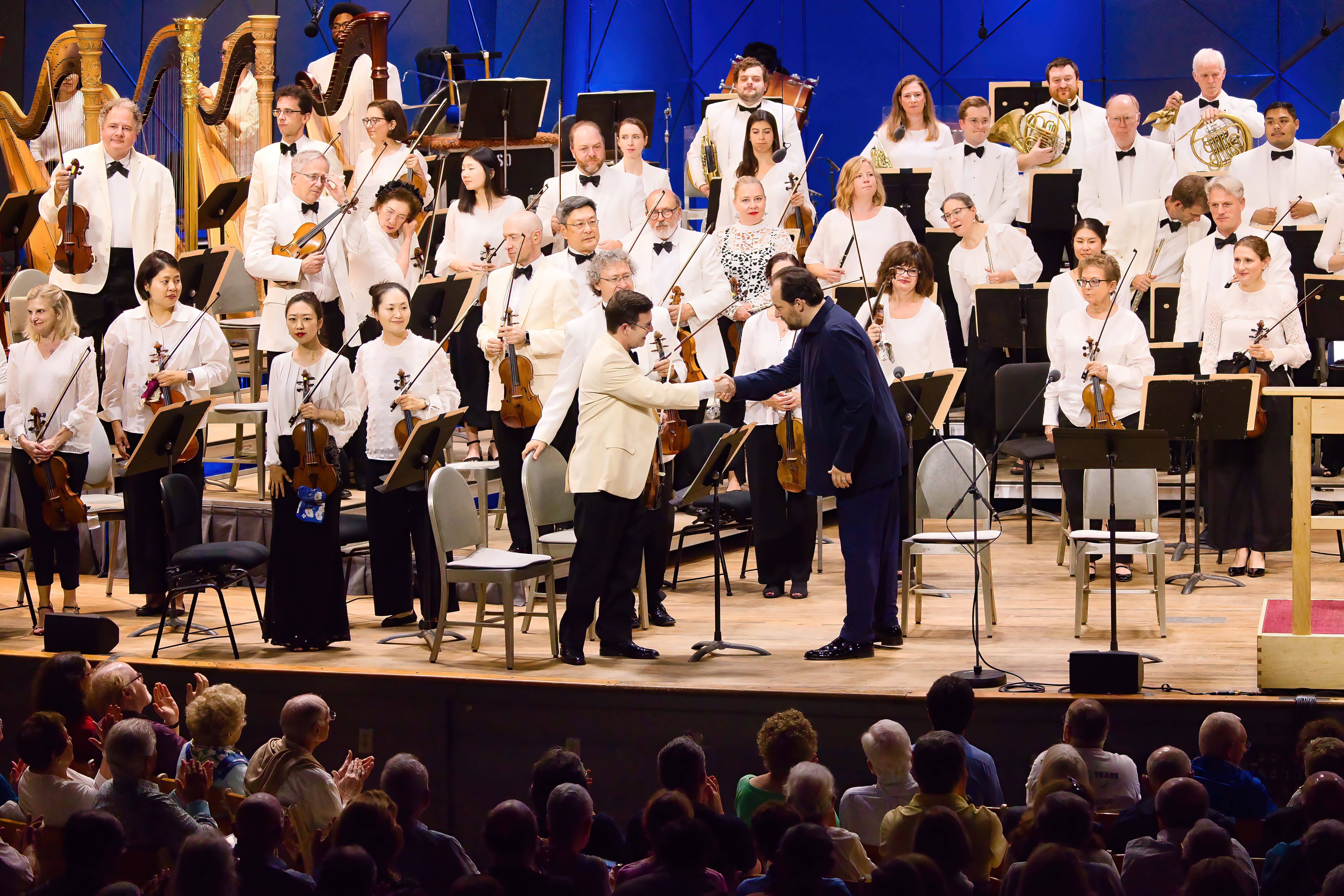 Andris Nelsons shakes hands with BSO concertmaster Nathan Cole