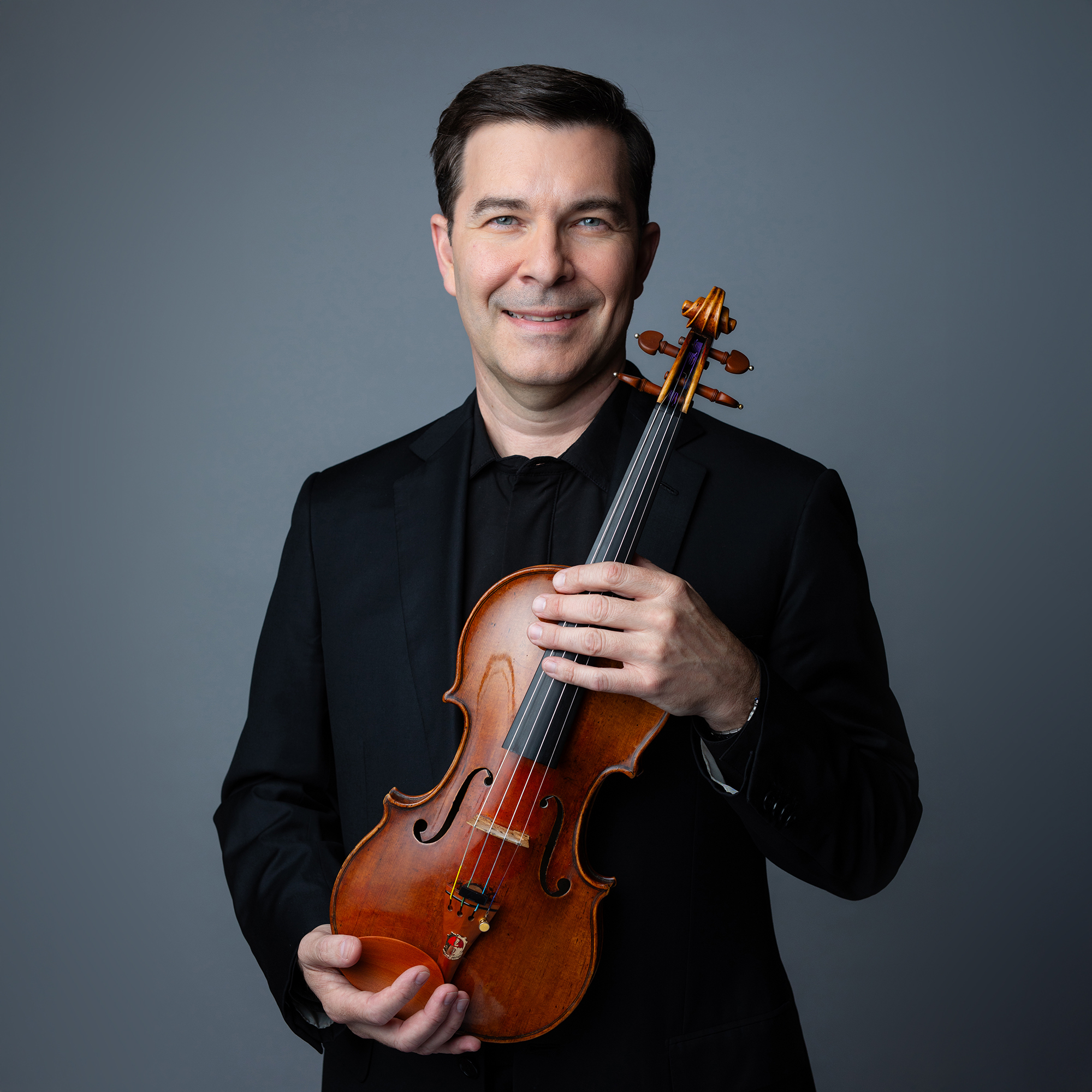 Nathan Cole holding a violin