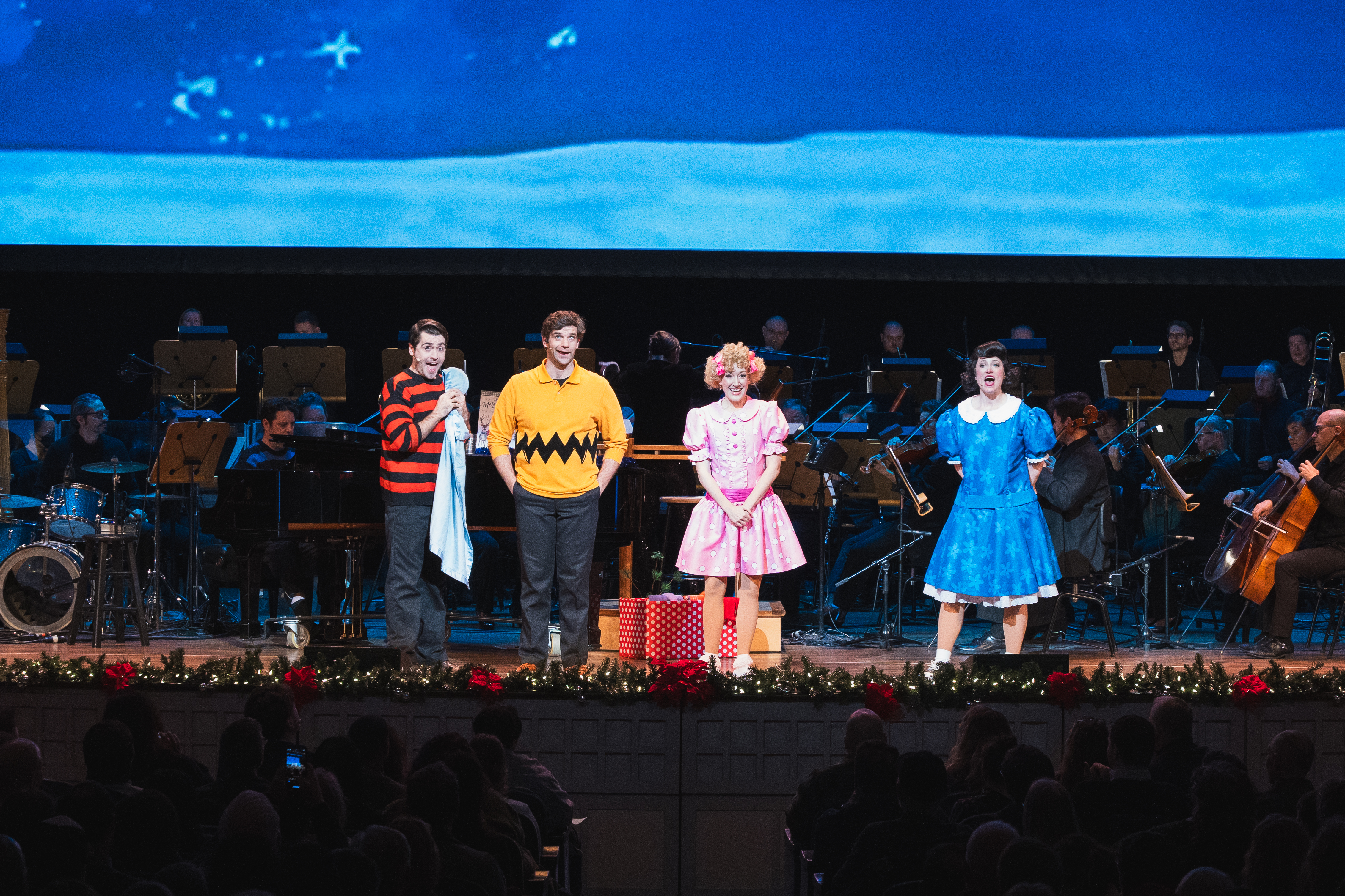 Four performers on stage in A Charlie Brown Christmas