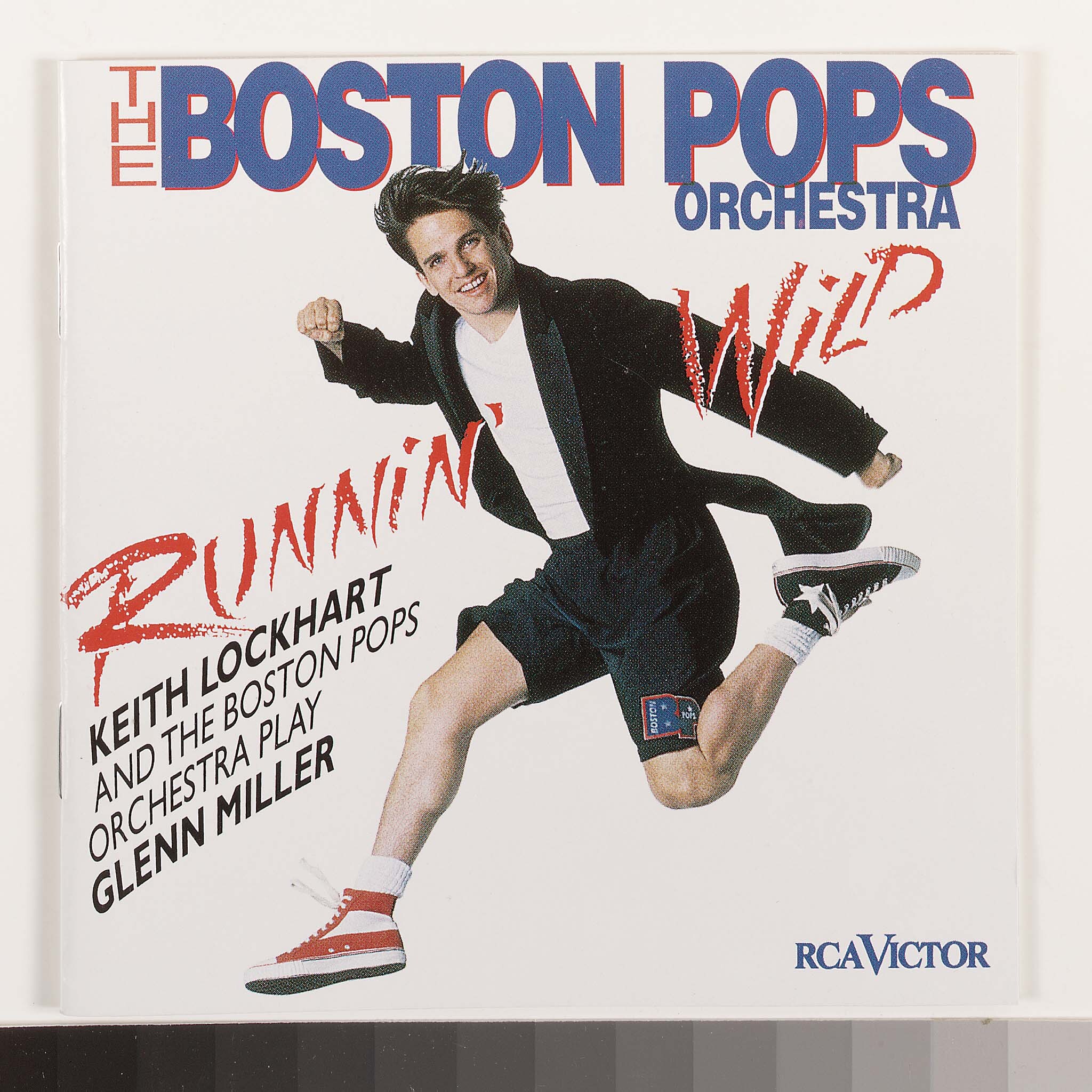 On the cover of Runnin' Wild, Keith is smiling and running in red and black sneakers, wearing shorts and a t-shirt under a black tailcoat.