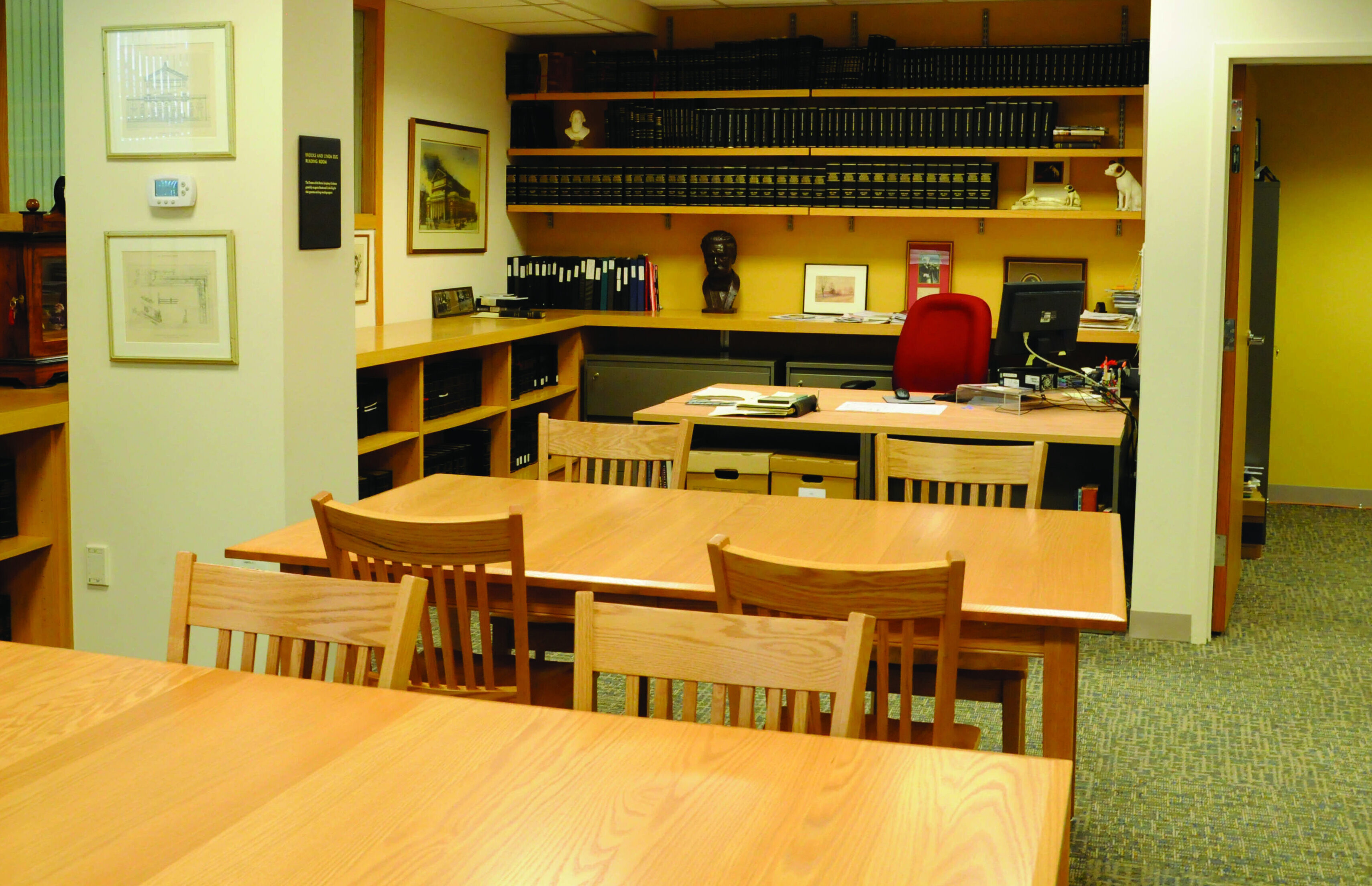The Archives Reading Room has two tables and a desk, with books lining the walls