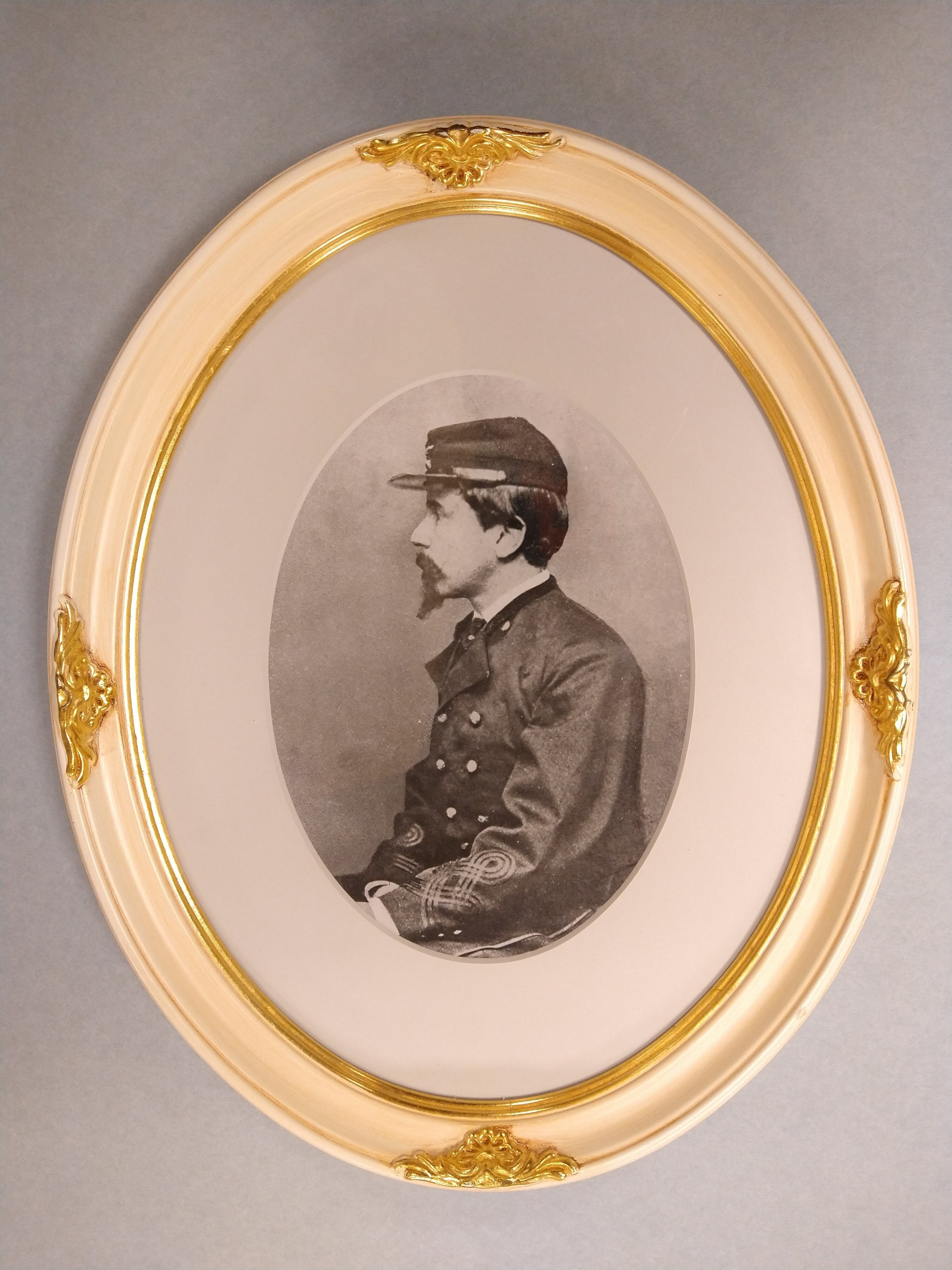 Framed portrait of a young Henry Lee Higginson in Union military dress, seated in profile
