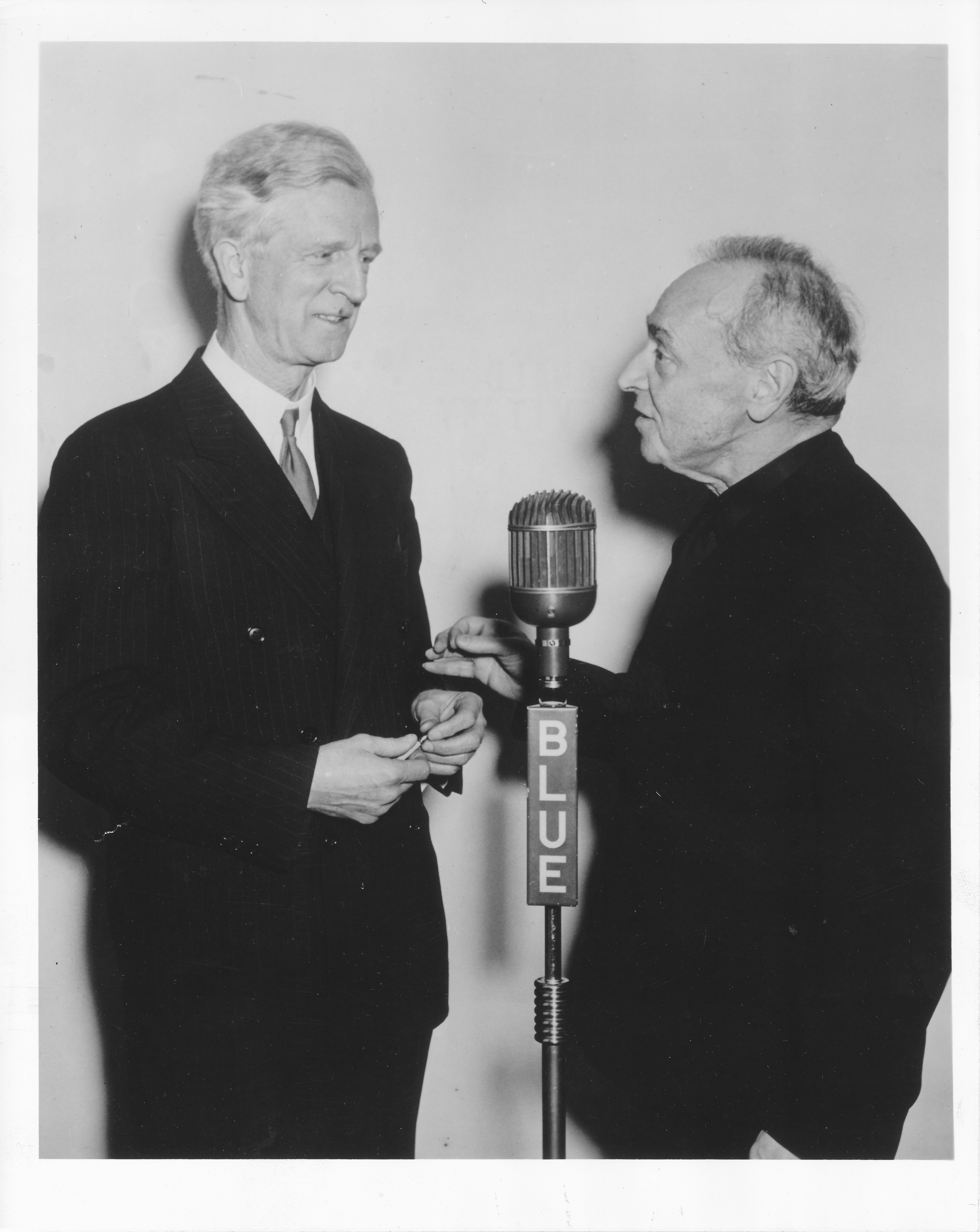 NBC Blue Network radio announcer James G. McDonald and Serge Koussevitzky stand at a microphone shortly after the BSO returned to the airwaves, January 1943