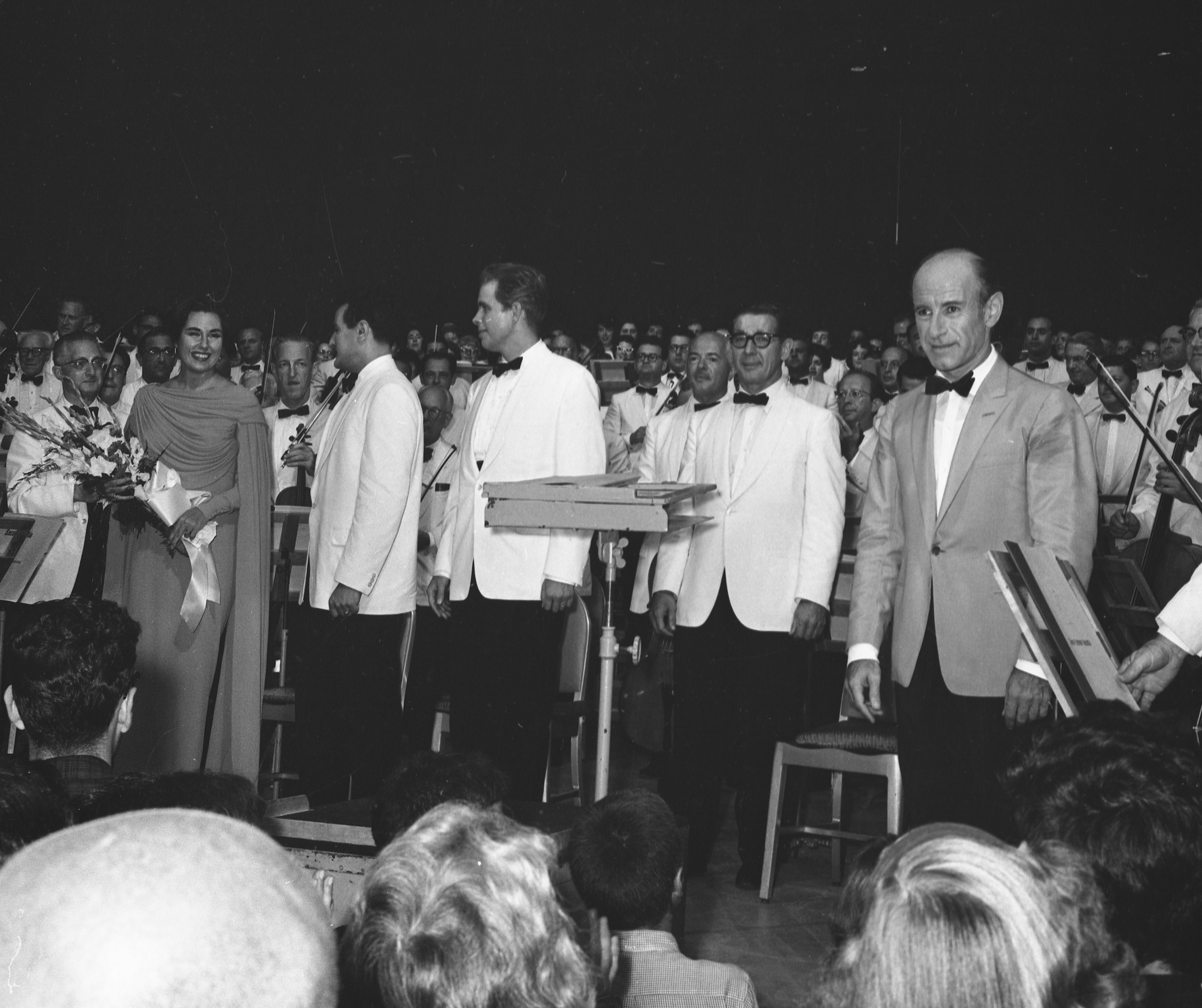 Performers stand on stage after a performance