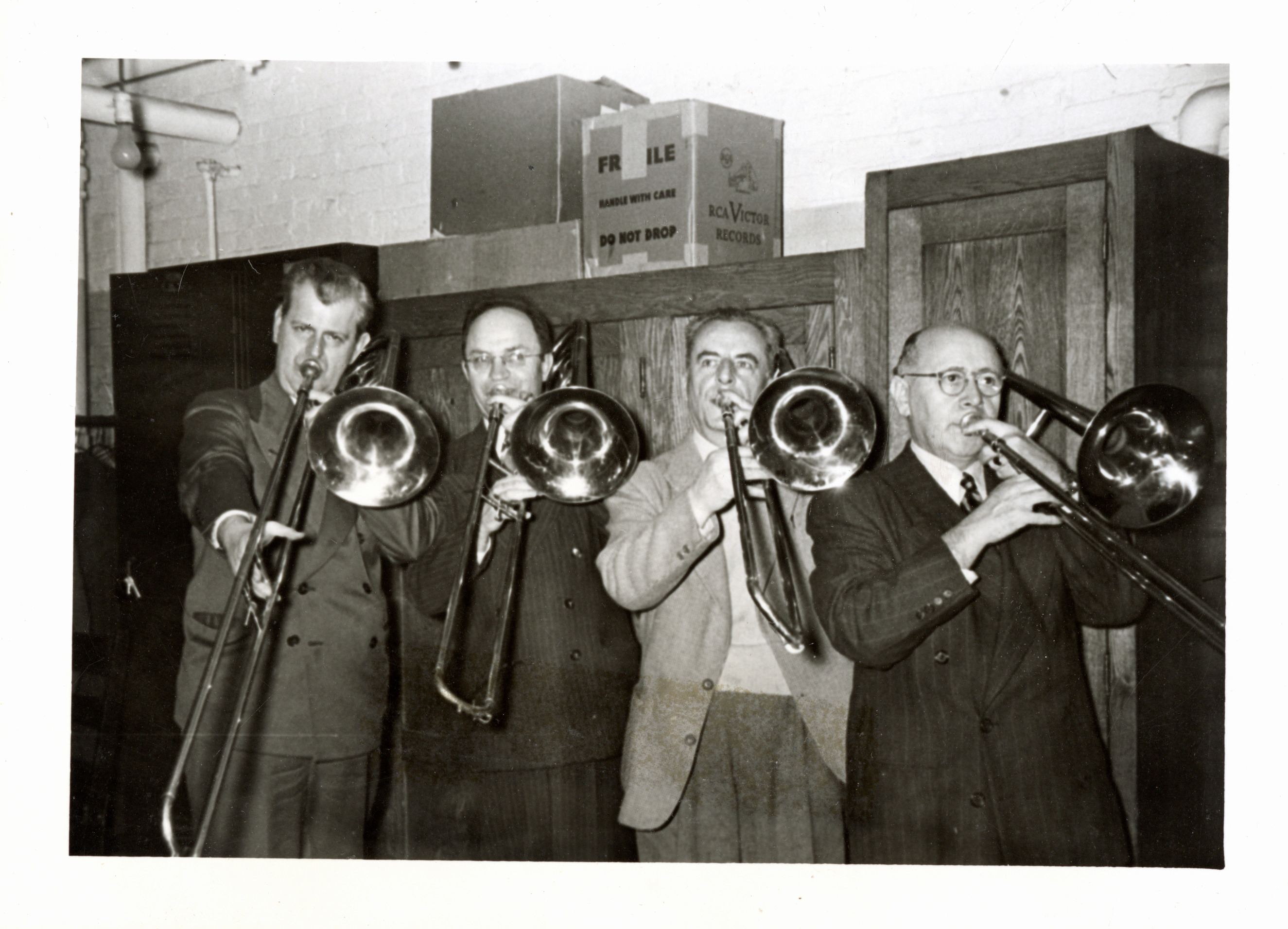 Members of the BSO trombone section pose backstage with their instruments