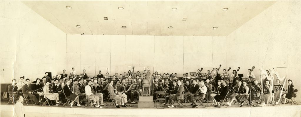 Serge Koussevitzky stands in front of the Tanglewood Music Center Orchestra in the Music Shed during the summer of 1942