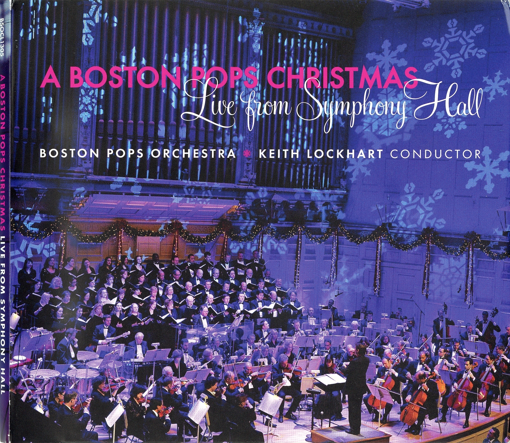 Boston Pops Christmas Live from Symphony Hall album cover depicts the orchestra and chorus on stage at Symphony Hall with Keith Lockhart conducting, with snowflake light displays over the organ and walls