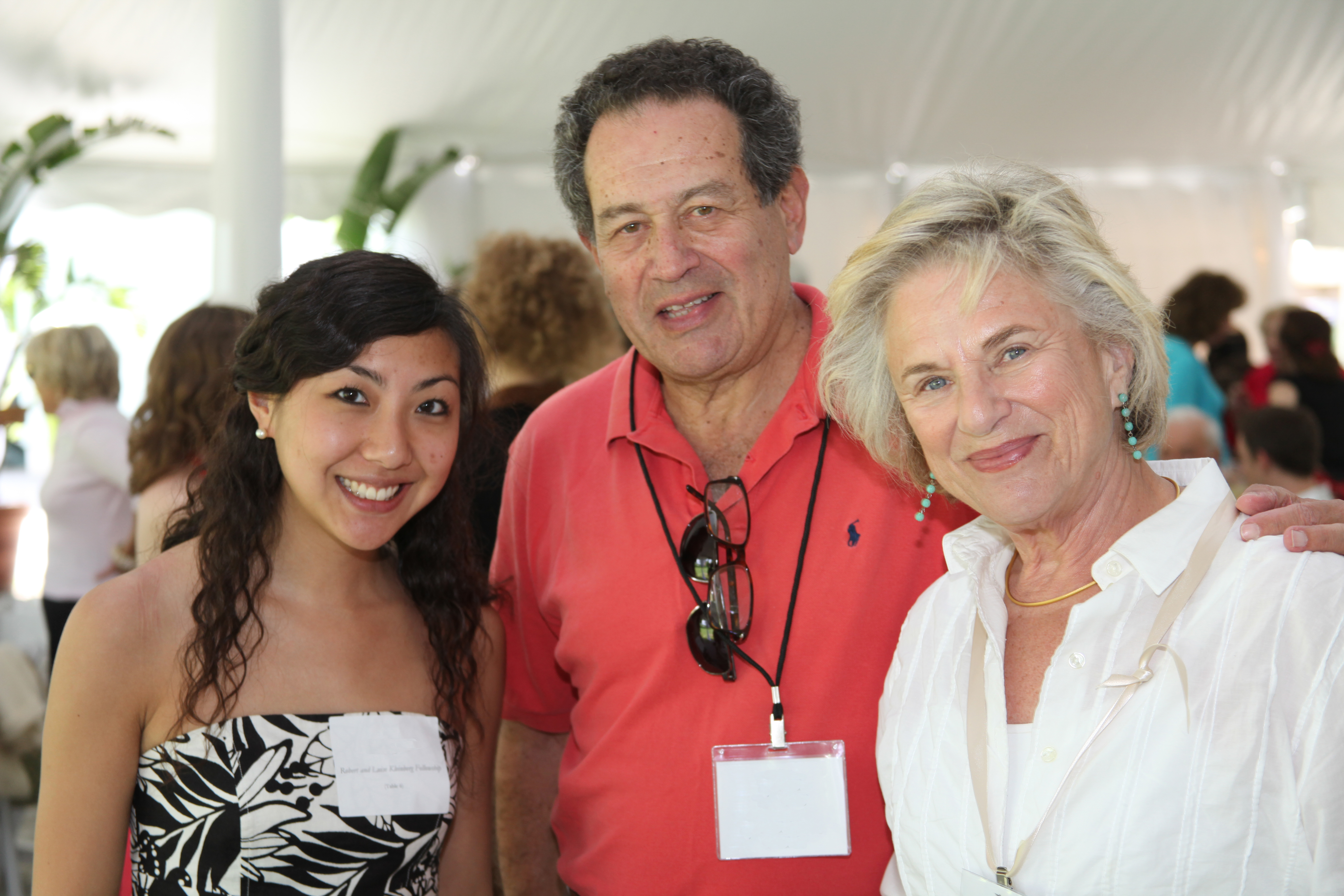 A TMC Fellow and two donors at an event