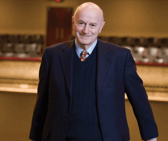 portrait of Dick Morse in a dark suit with a red tie