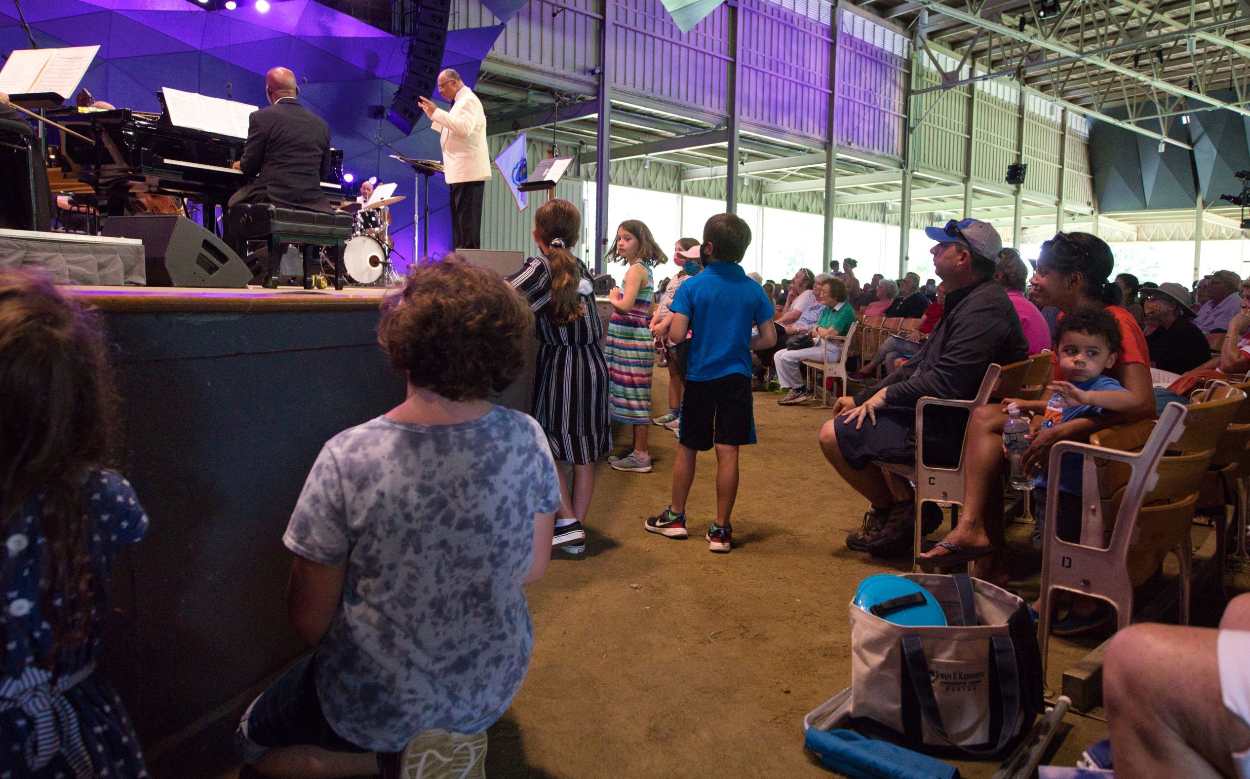 Children and adults watch Byron Stripling on stage.