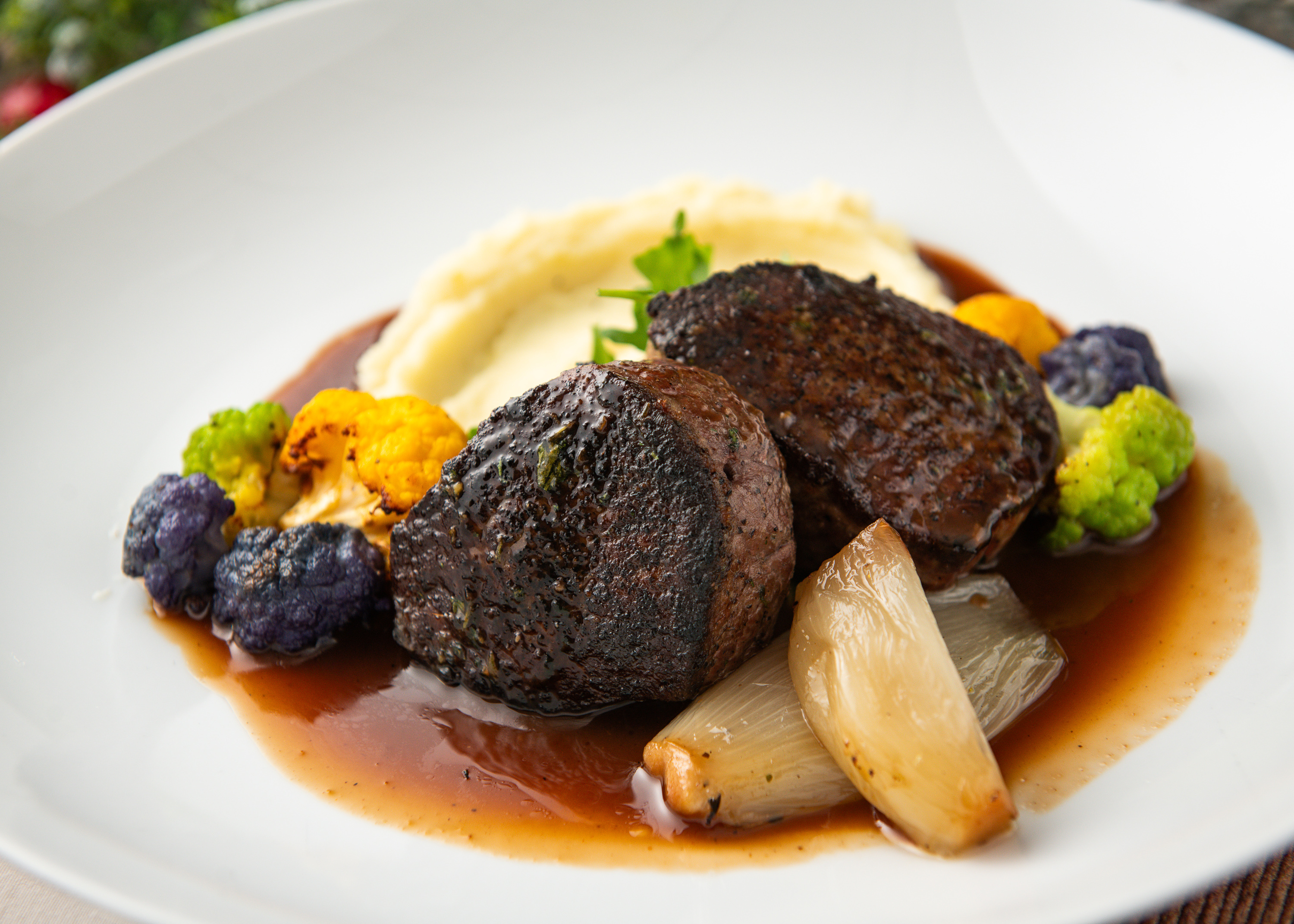 Seared Tenderloin with Mashed Potatoes, Caramelized Shallot, Tricolor Cauliflower, & Red Wine Sauce.