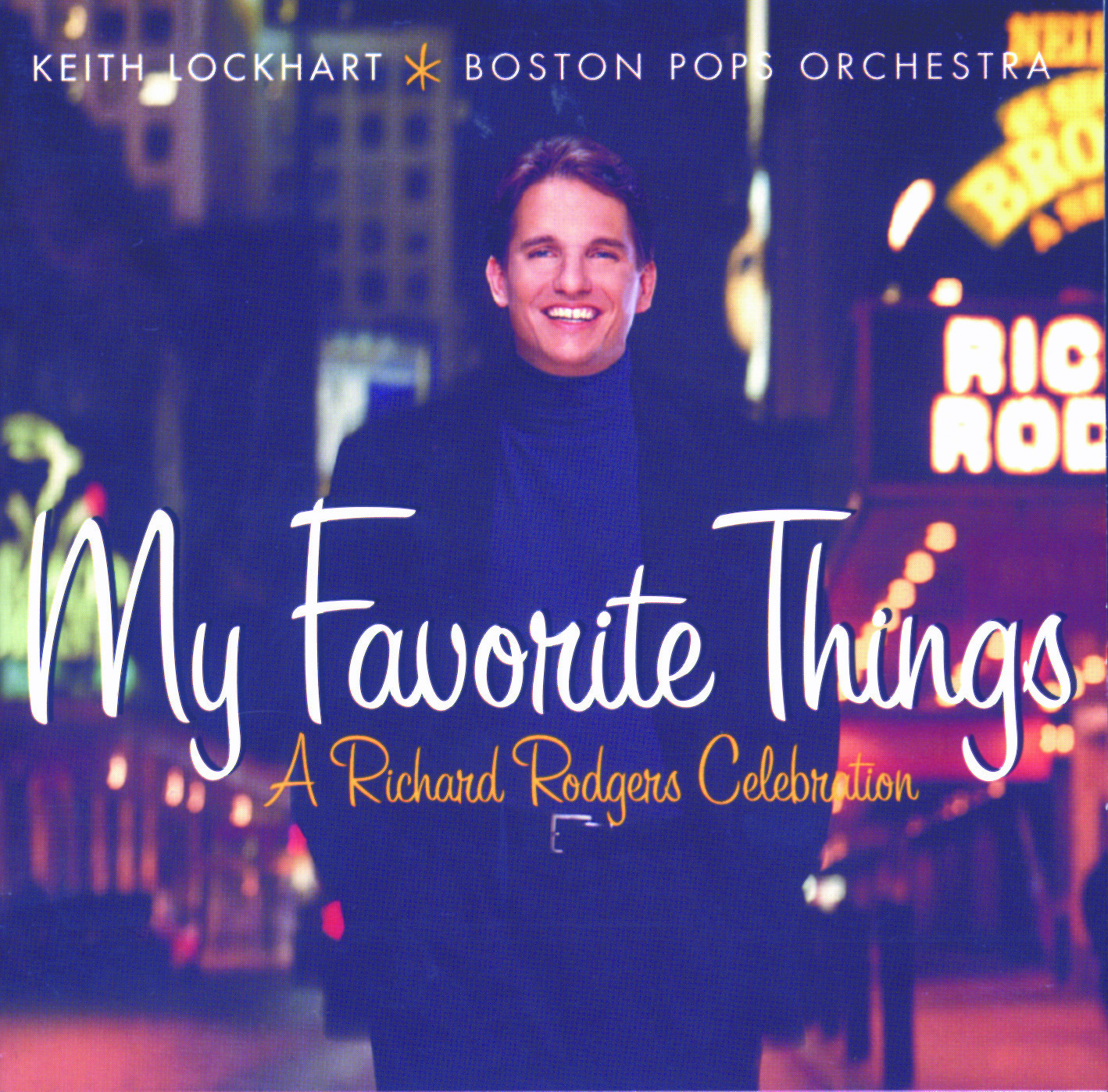 My Favorite Things album cover shows Keith Lockhart dressed in dark turtleneck, blazer and slacks in a nighttime city scene