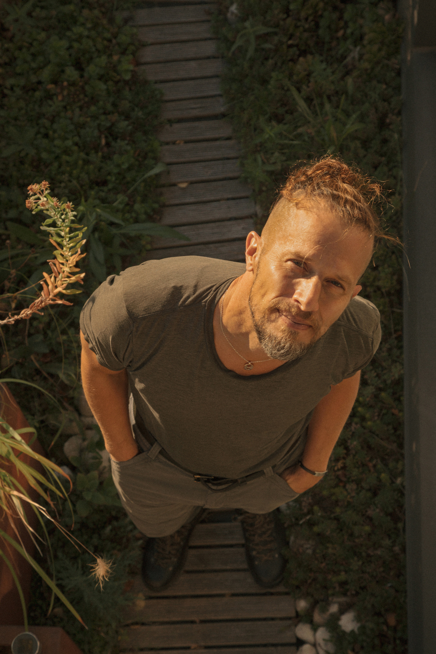 D. Graham Burnett photo from overhead angle. He is wearing a grey shirt and pants.