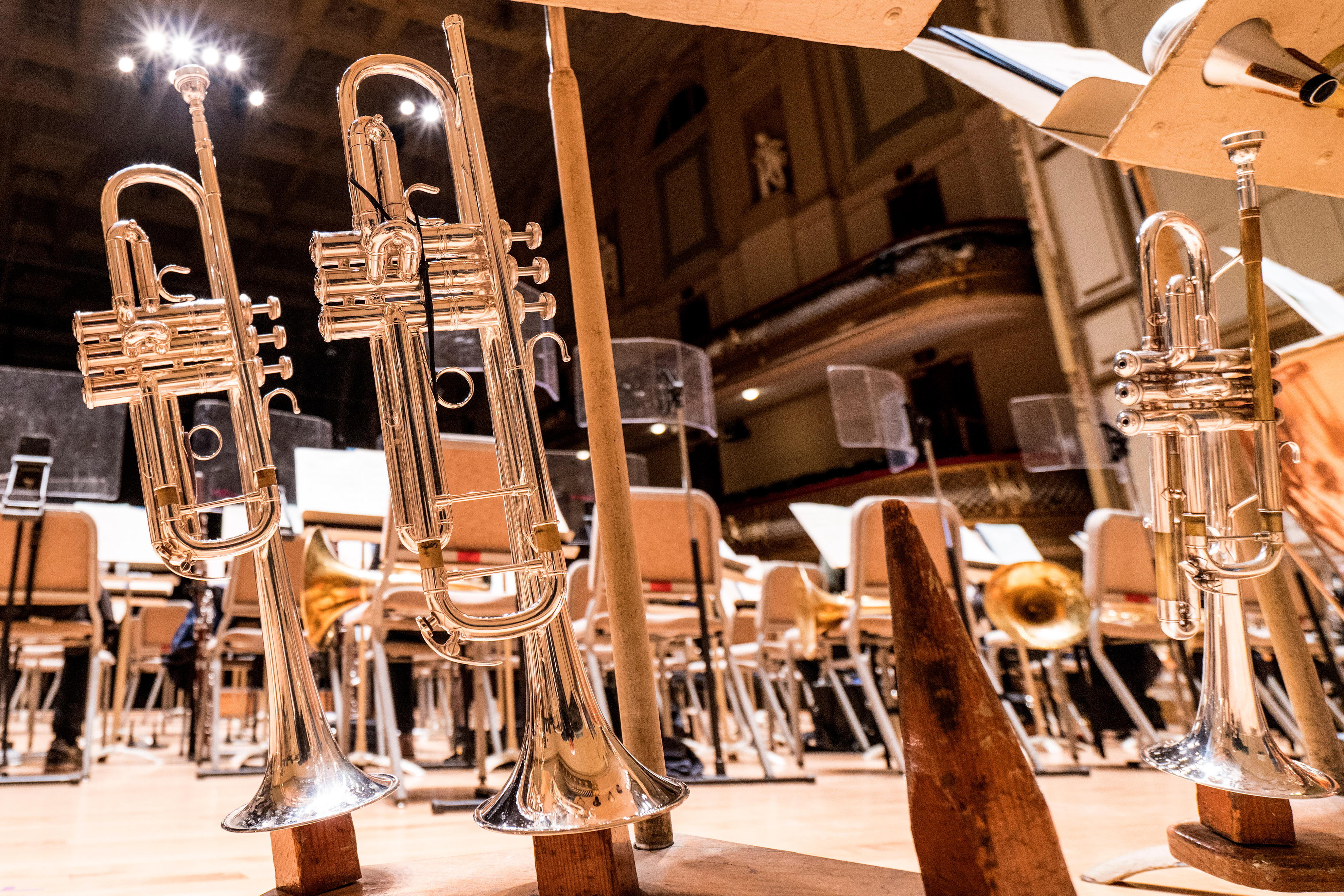 Three trumpets in their stands on the Symphony Hall stage from the stage perspective