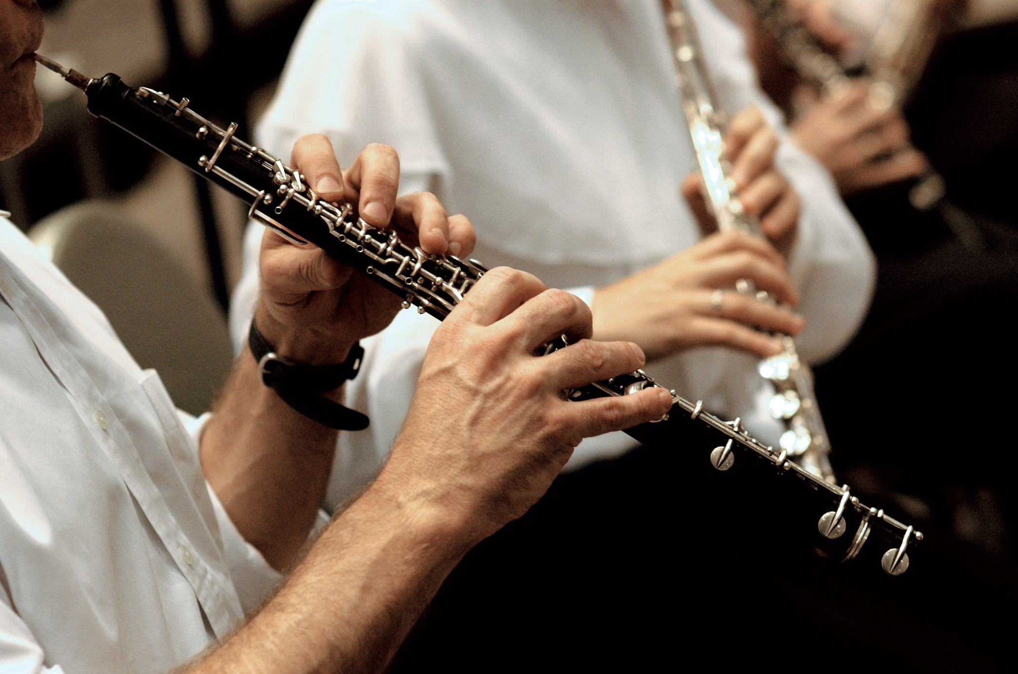 an oboe an flute being played in close up