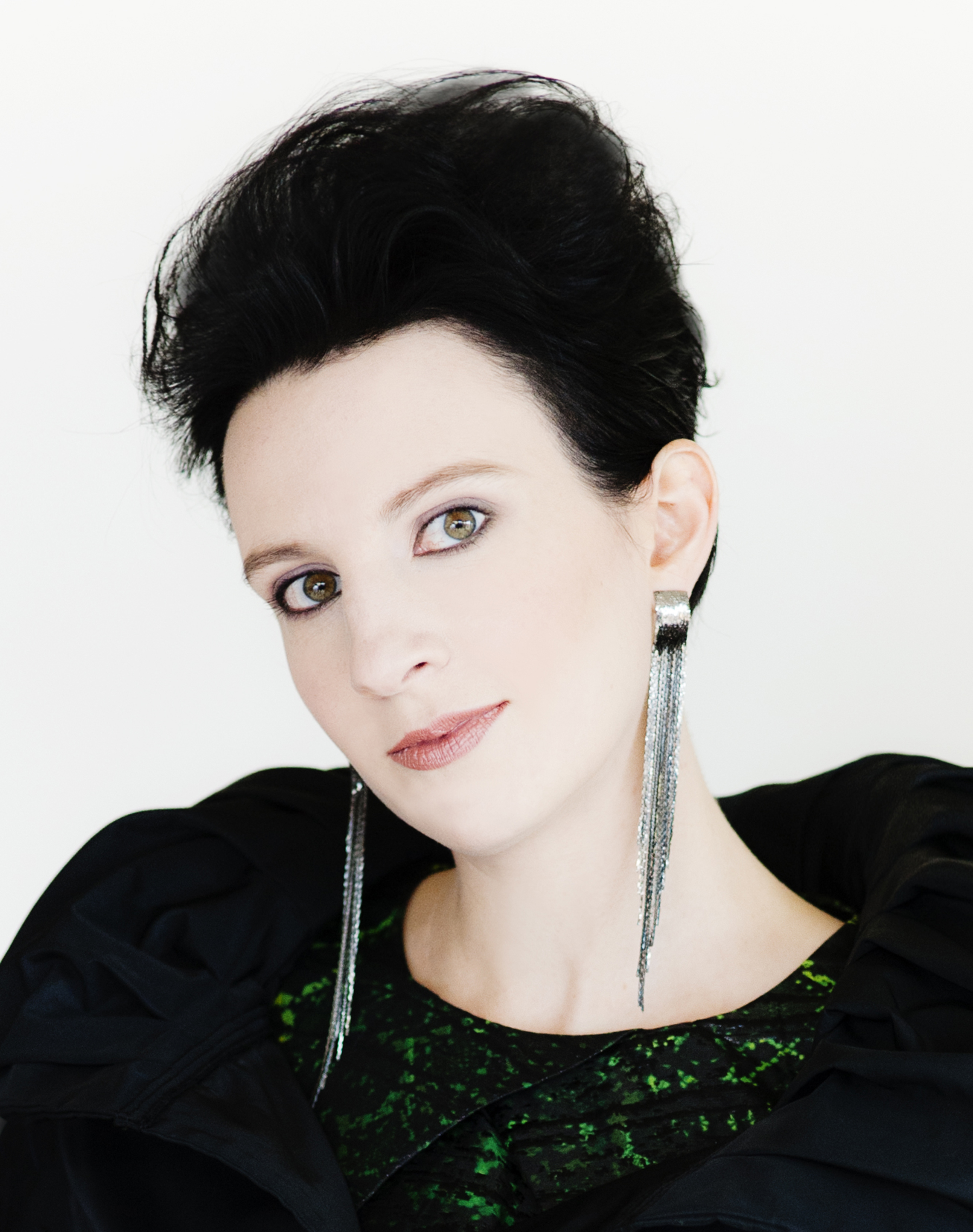 Lindsay Kesselman headshot wearing a dark top and long earrings