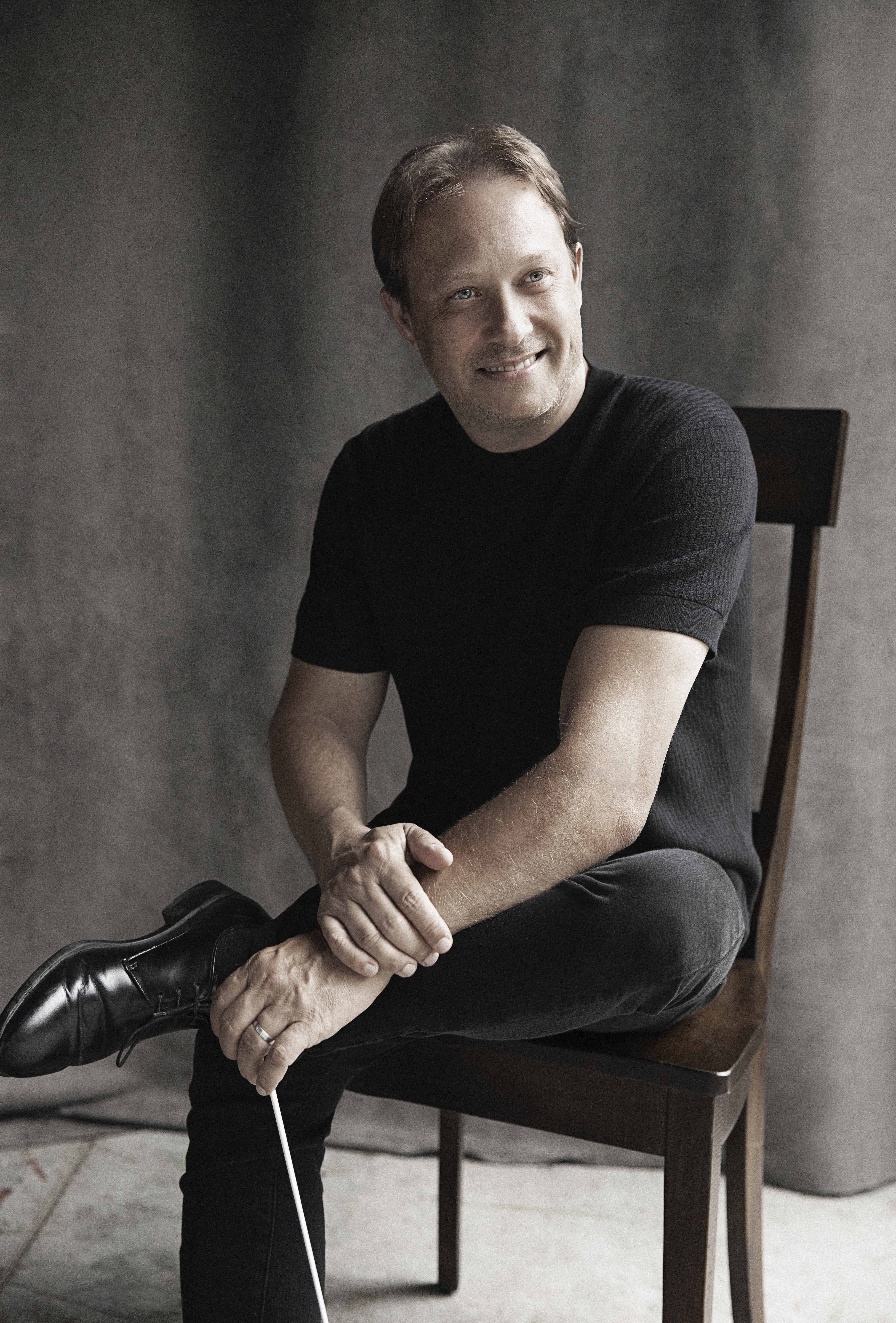 Ludovic Morlot sitting holding a baton