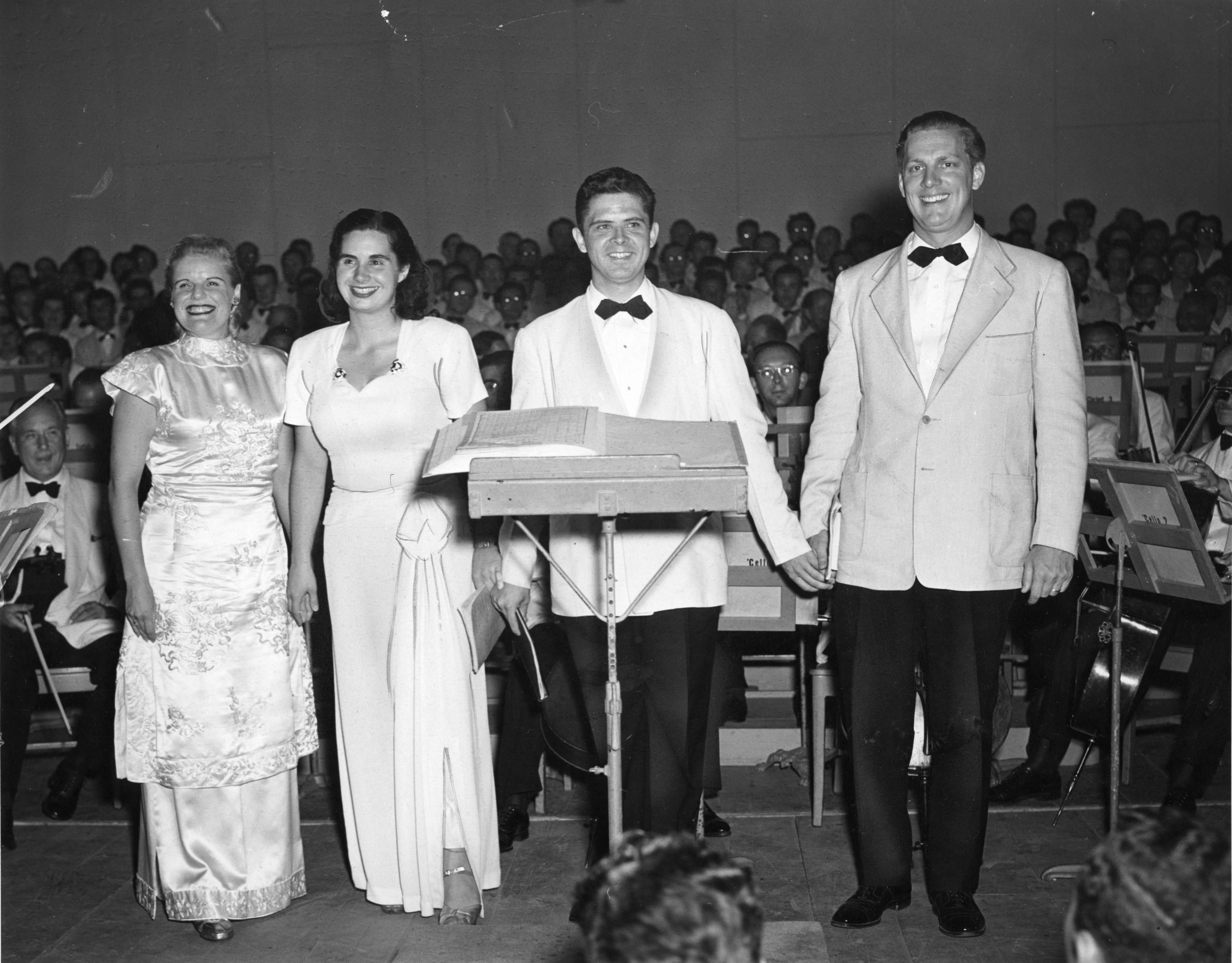 Frances Yeend, Eunice Alberts, David Lloyd, and James Pease stand onstage at the curtain call following the BSO's performance of Beethoven's Symphony No. 9, ca. August 5, 1947