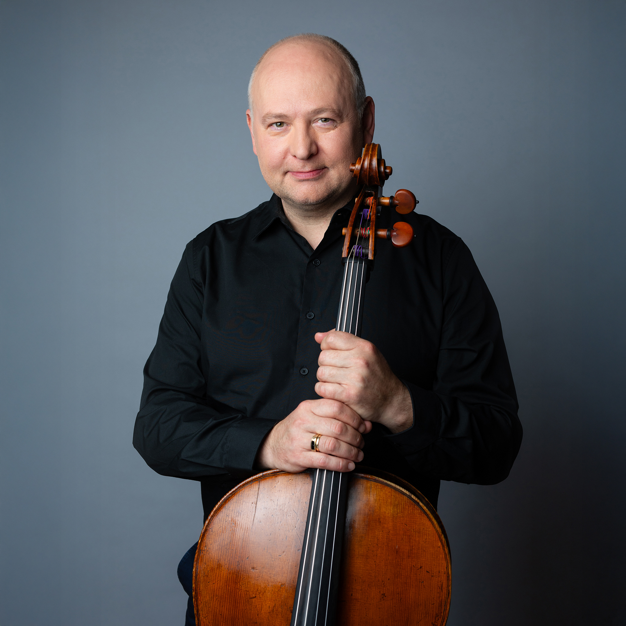 Mihail Jojatu headshot with cello