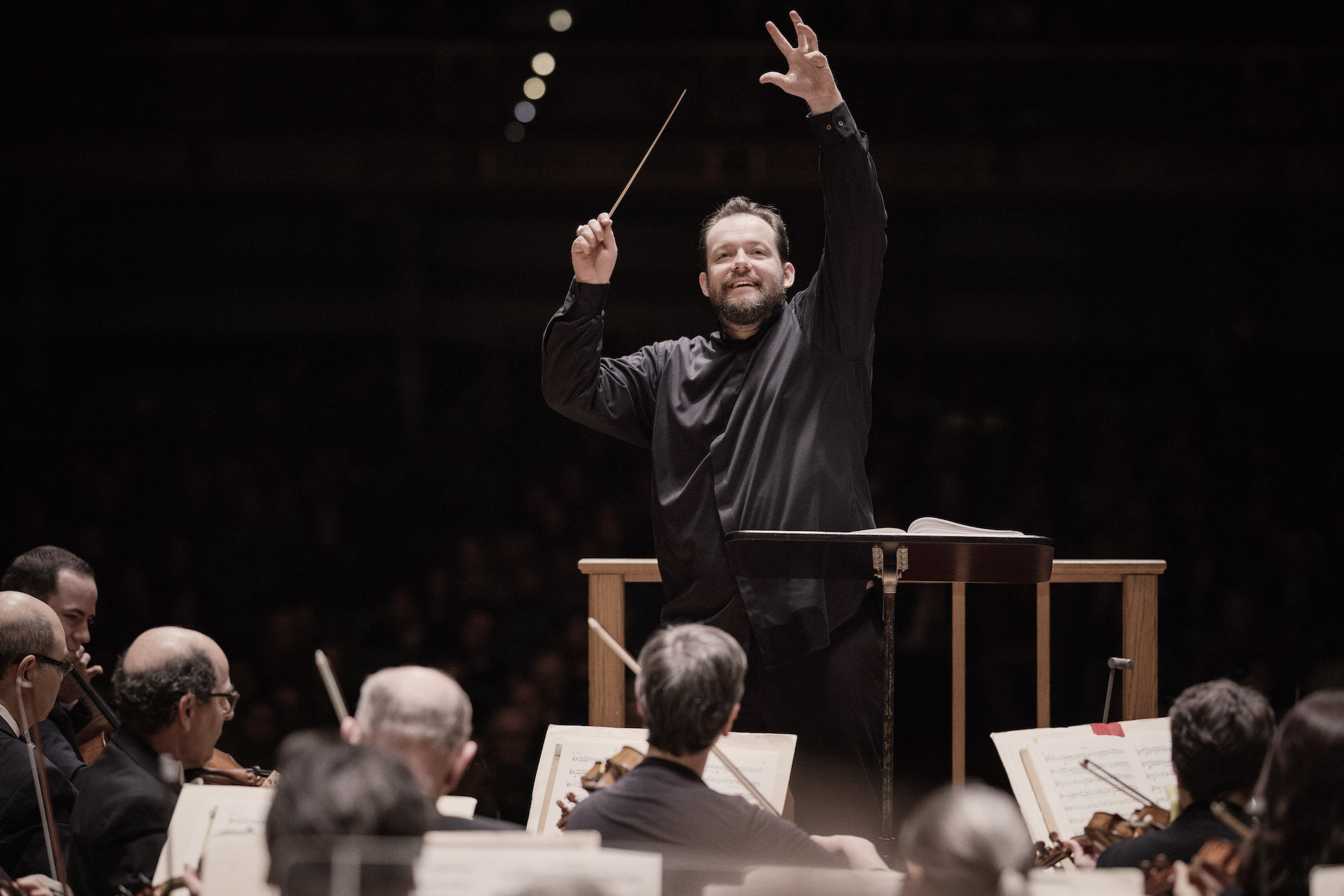 Andris Nelsons smiling while conducting