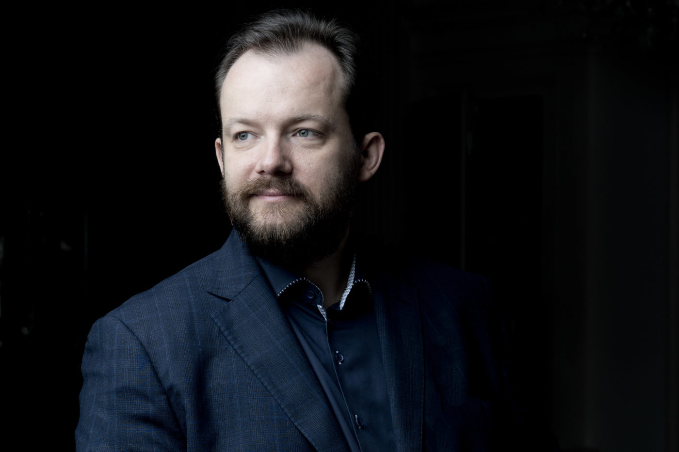 Andris Nelsons wearing a dark blue plaid suit