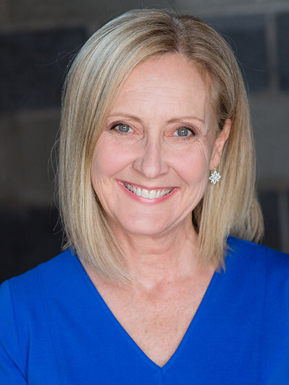 Mallory Thompson wearing a bright blue blouse