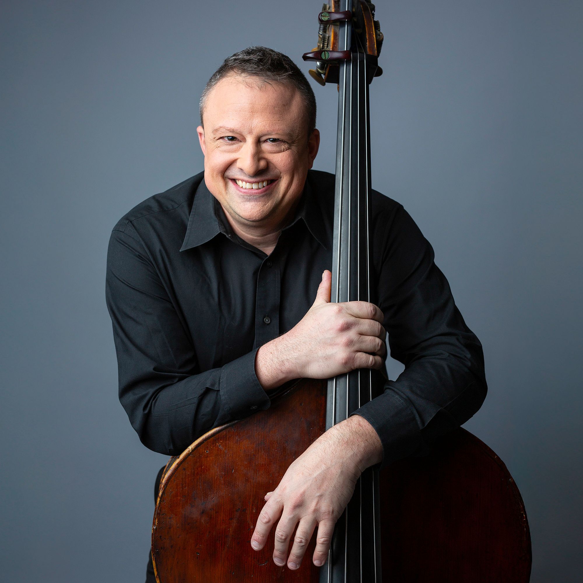 Benjamin Levy headshot with bass