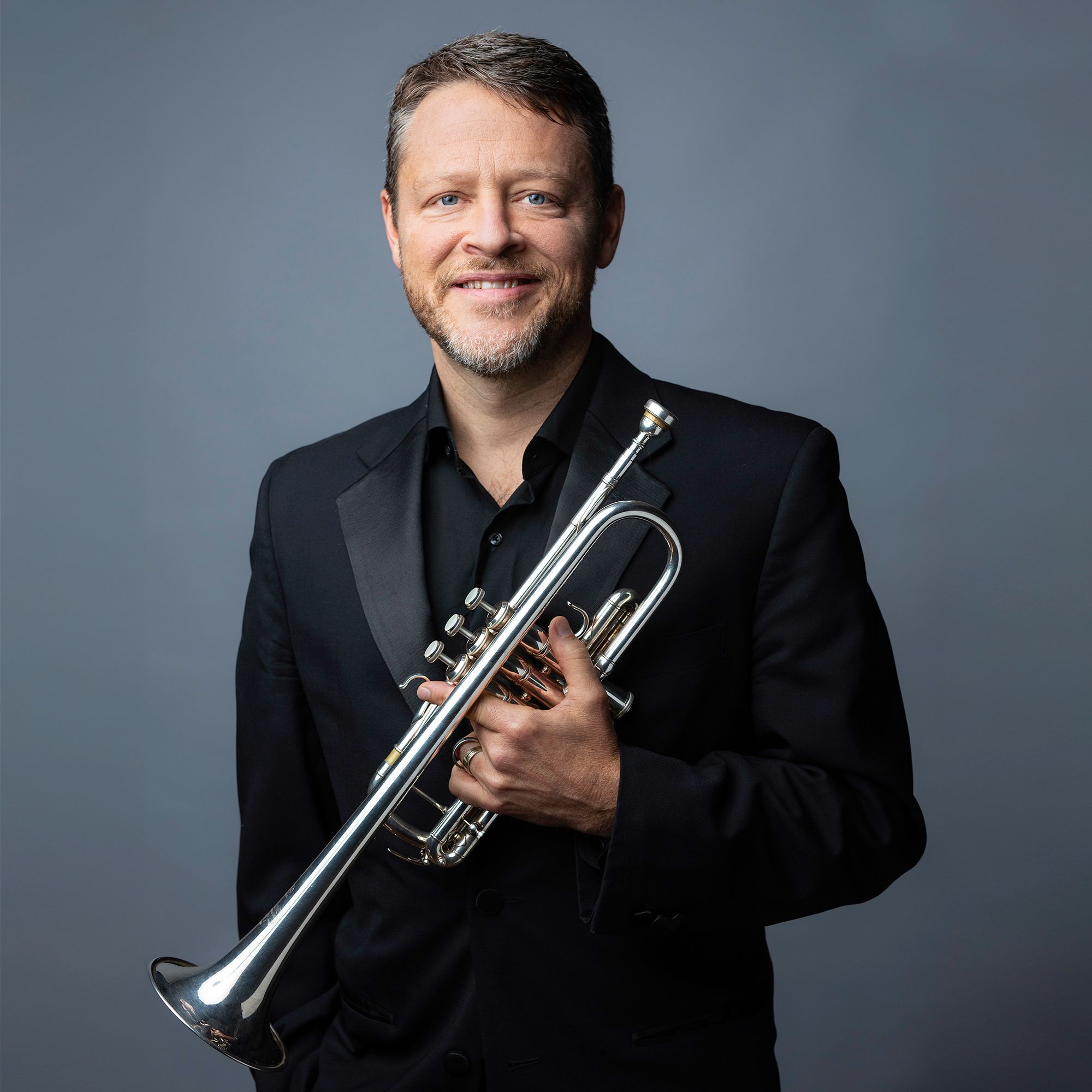 Benjamin Wright headshot with trumpet