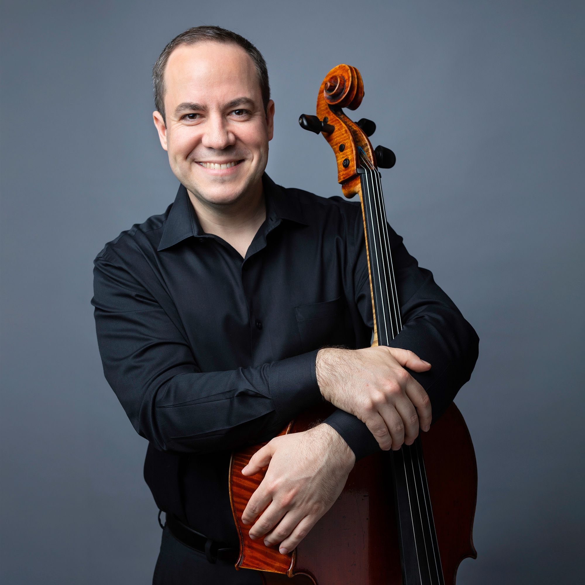Blaise Déjardin headshot with cello