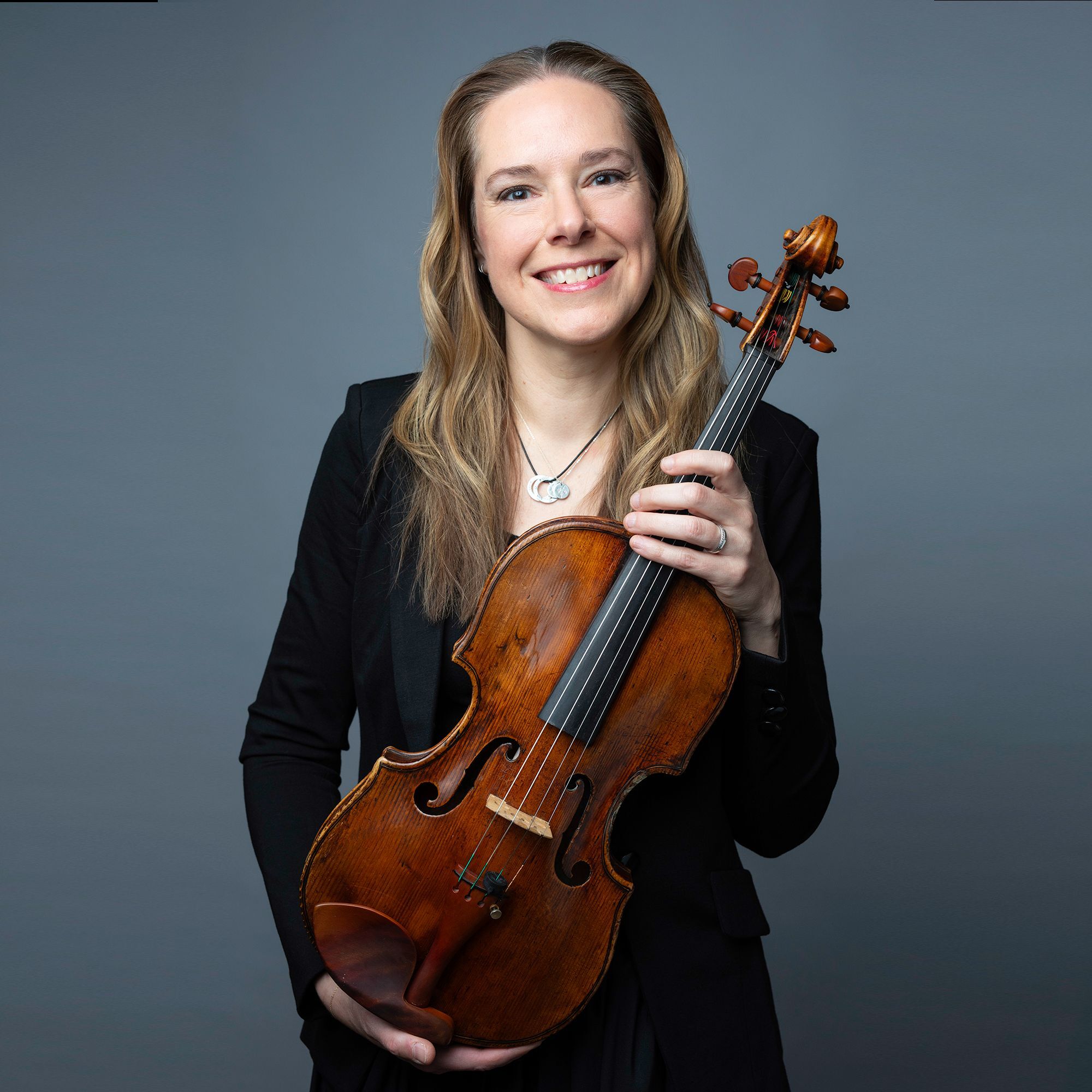 Cathy Basrak headshot with viola