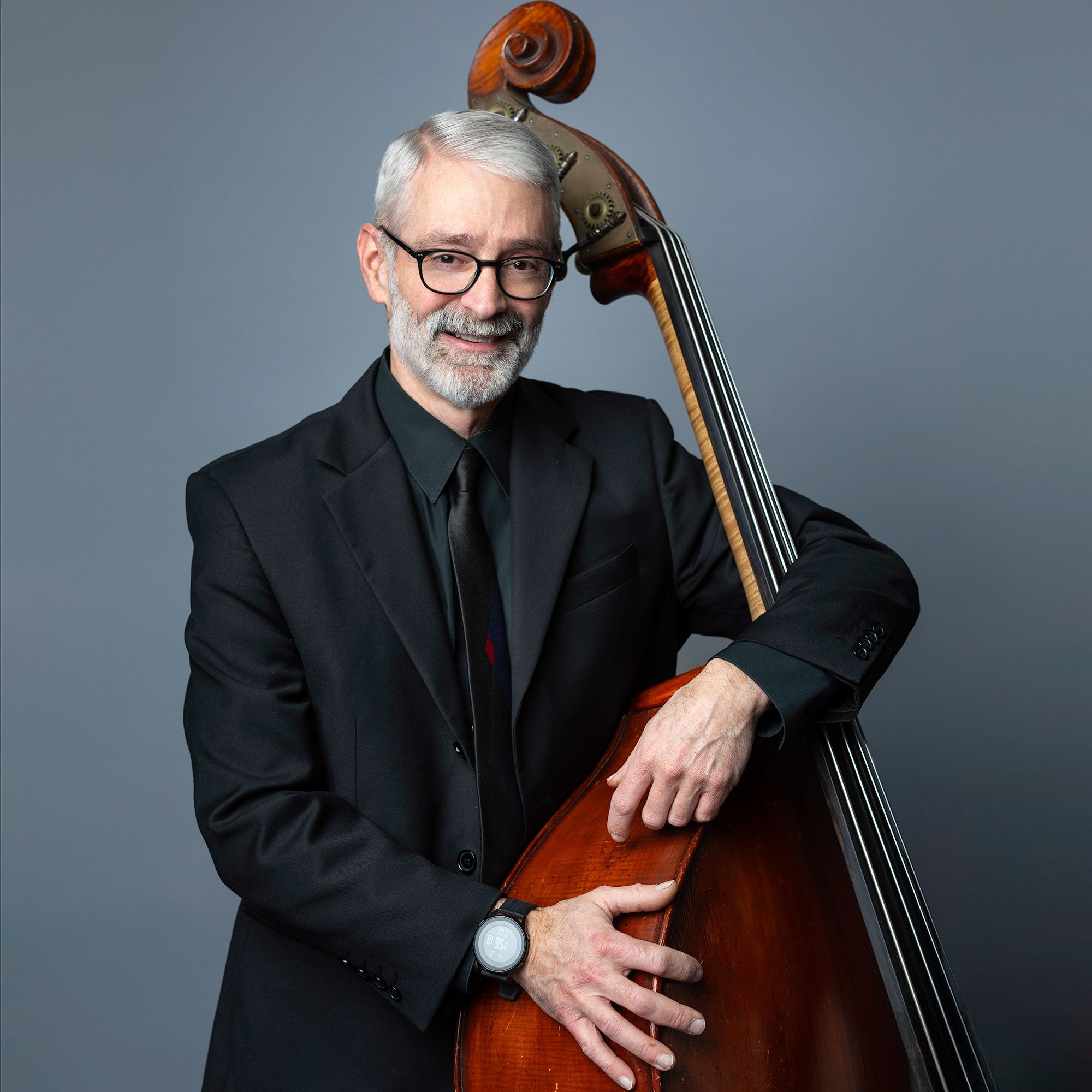 Dennis Roy headshot with bass