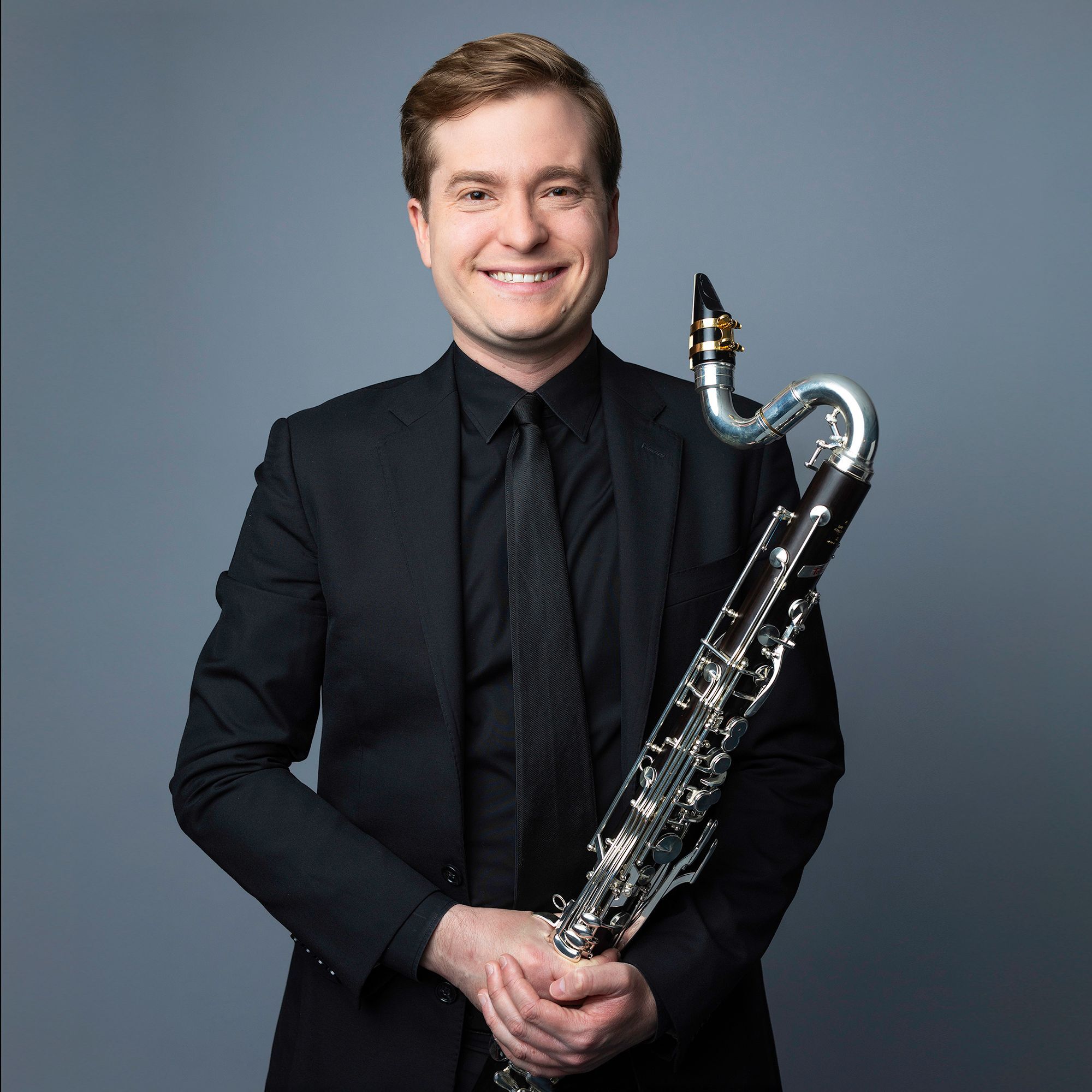 Andrew Sandwick holding bass clarinet