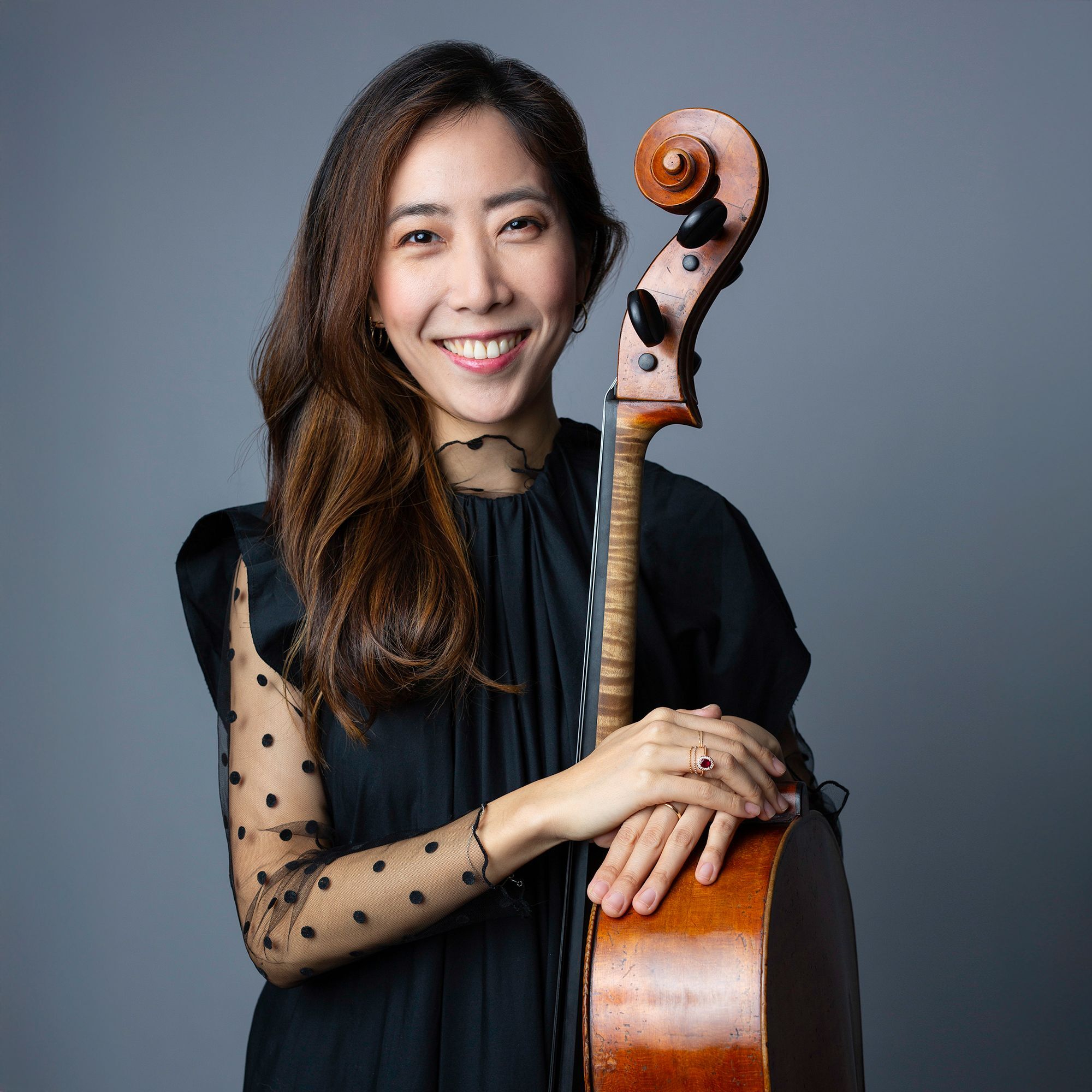 Christine Lee headshot standing with cello