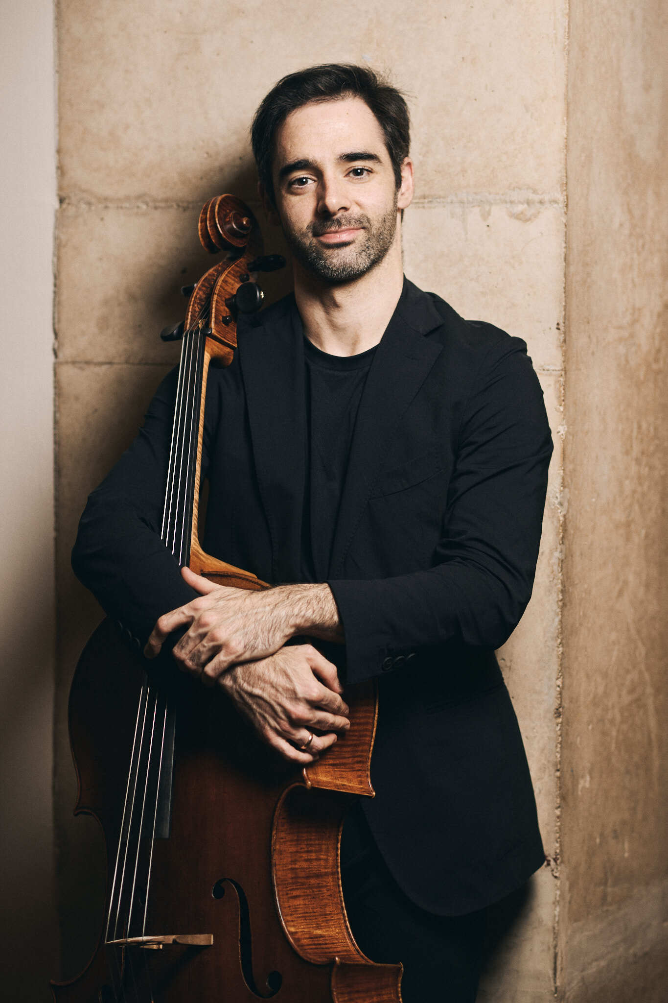 Pablo Ferrandez standing and hugging cello