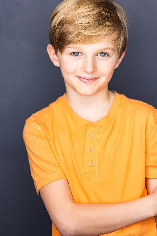 Quinn Murphy wearing a orange t-shirt