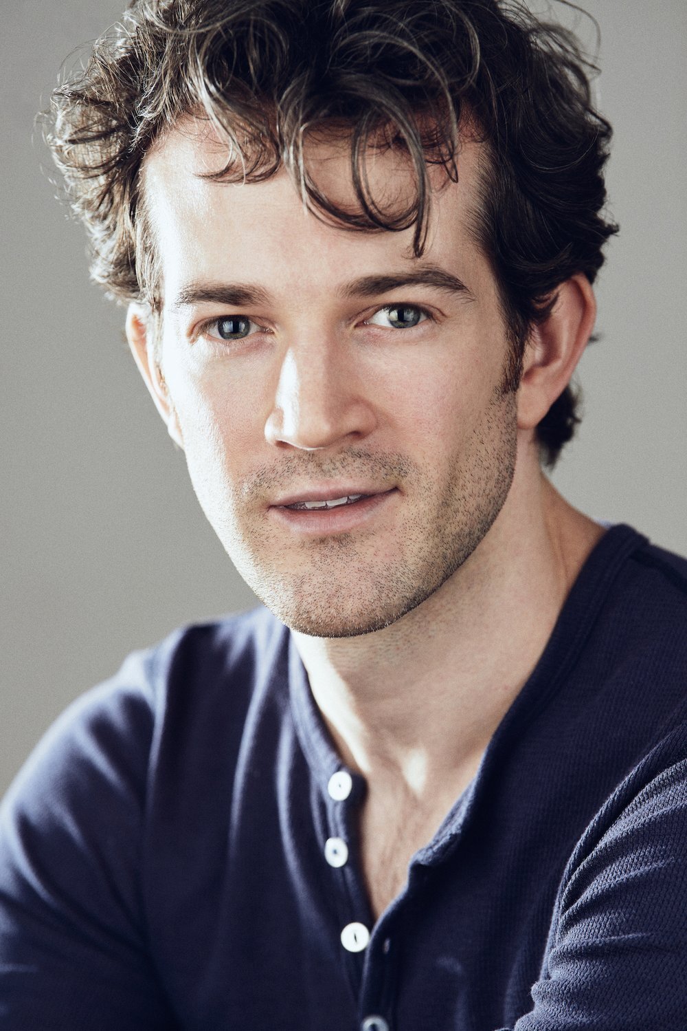 AJ Shively wearing an open collar long sleeve shirt