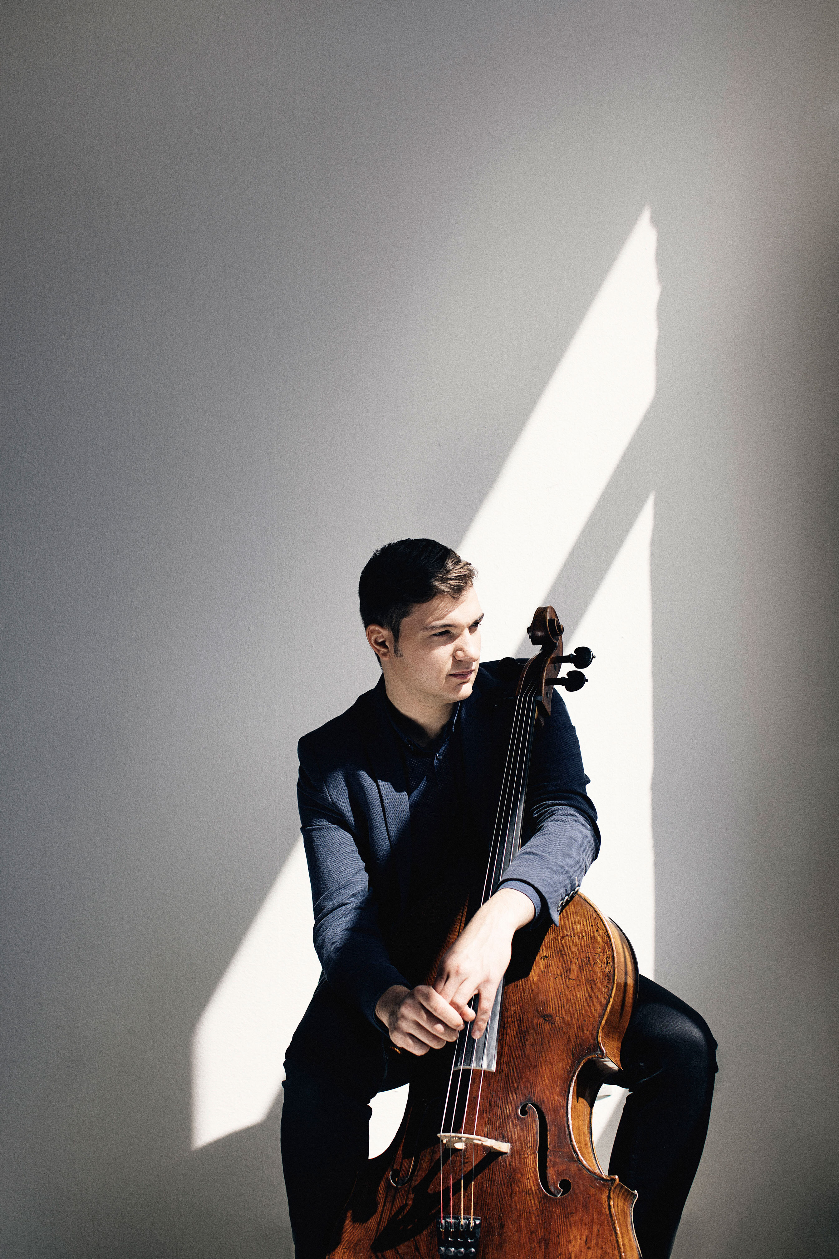 Andrei Ioniță sitting with a cello