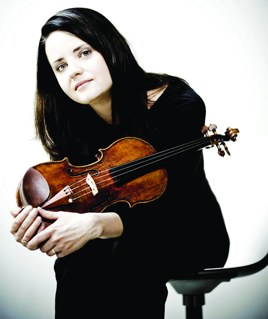 Baiba Skride sitting with her violin in her hands