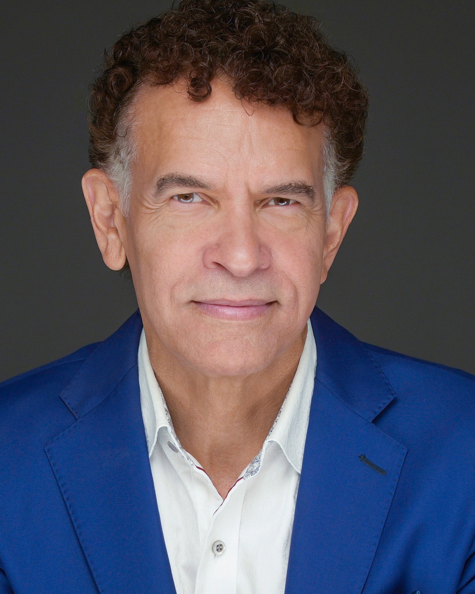 Headshot of Brian Stokes Mitchell wearing a royal blue jacket