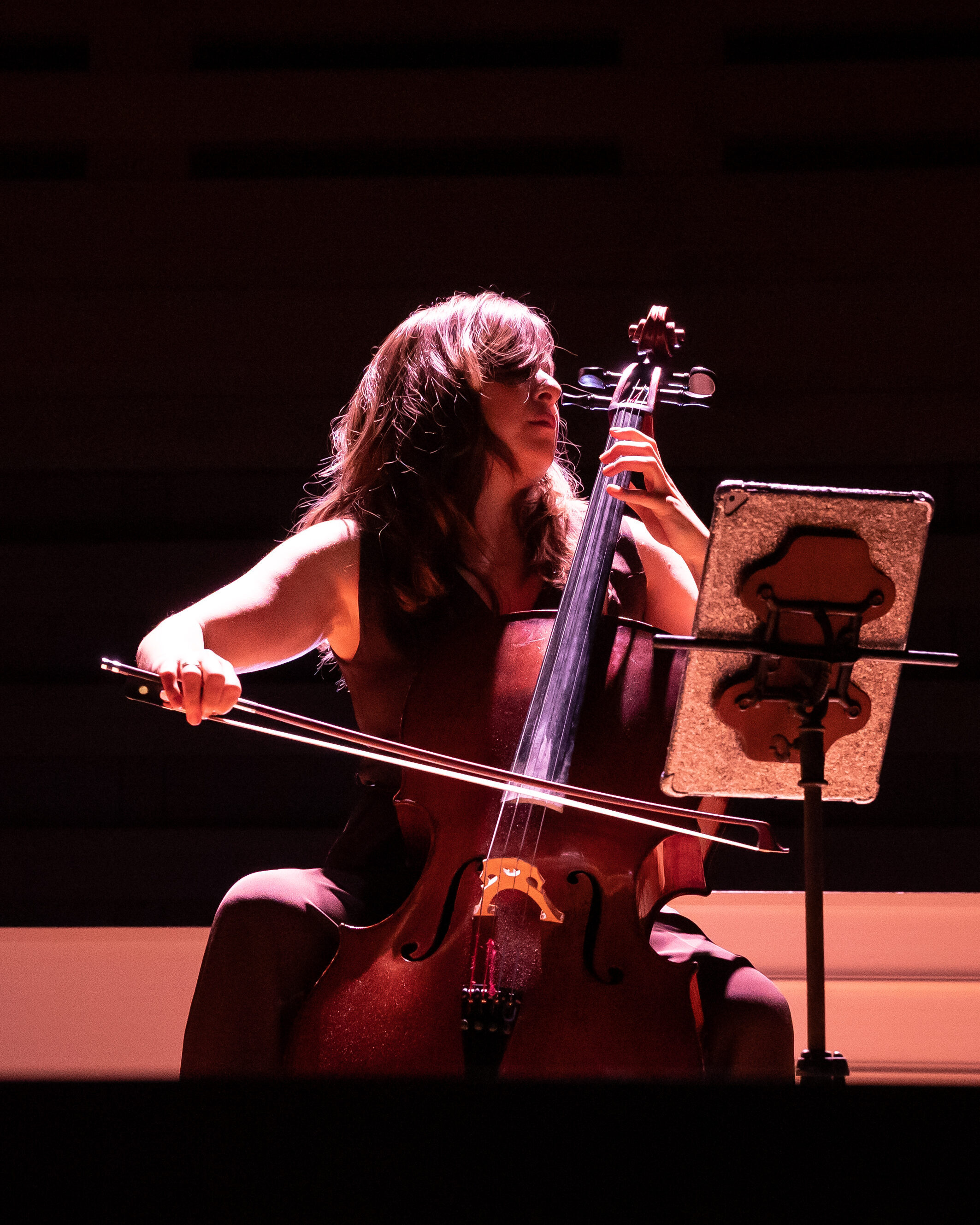 Woman playing a cello in the dark