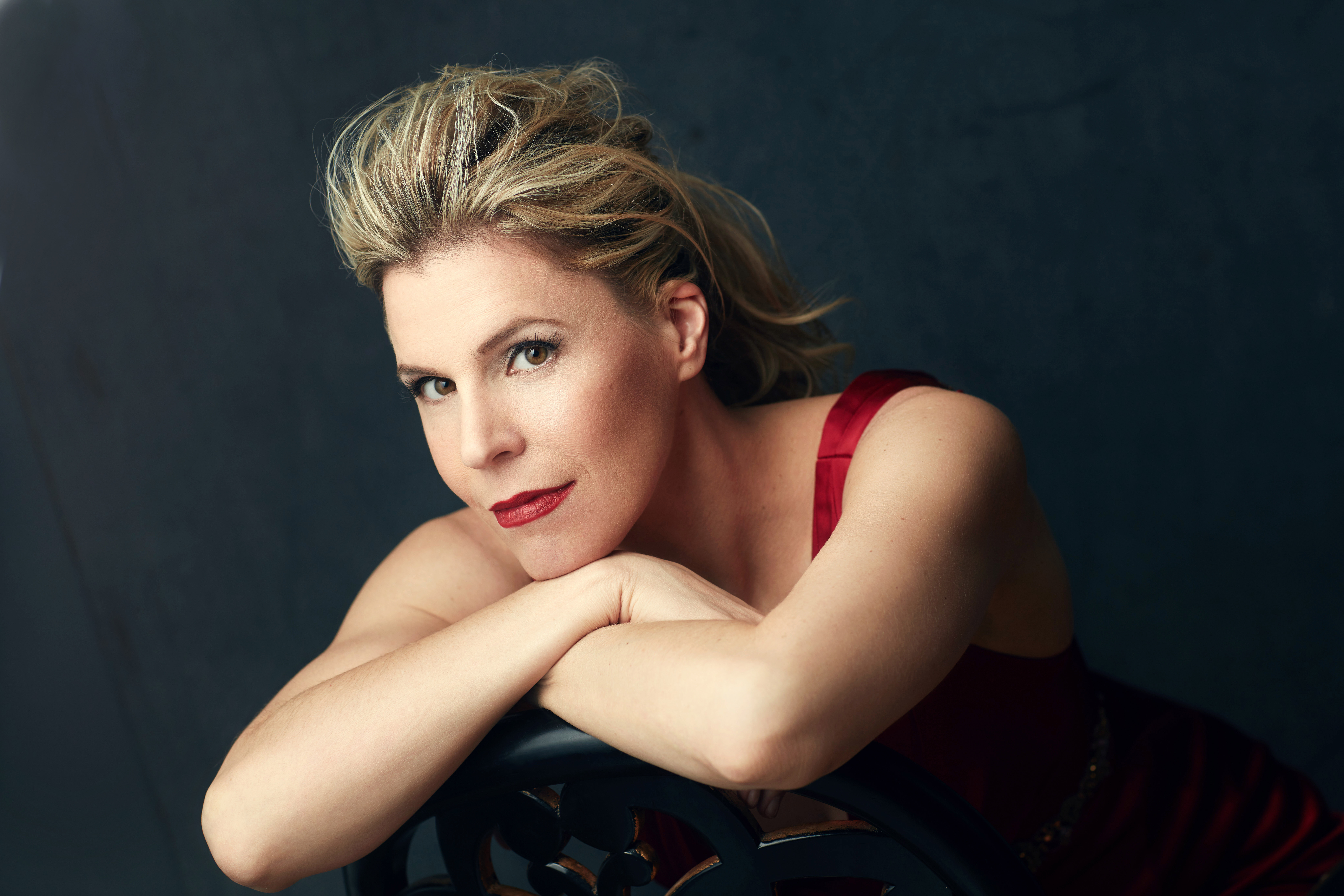 Georgia Jarman sitting backwards in a chair with her head resting on her crossed arms