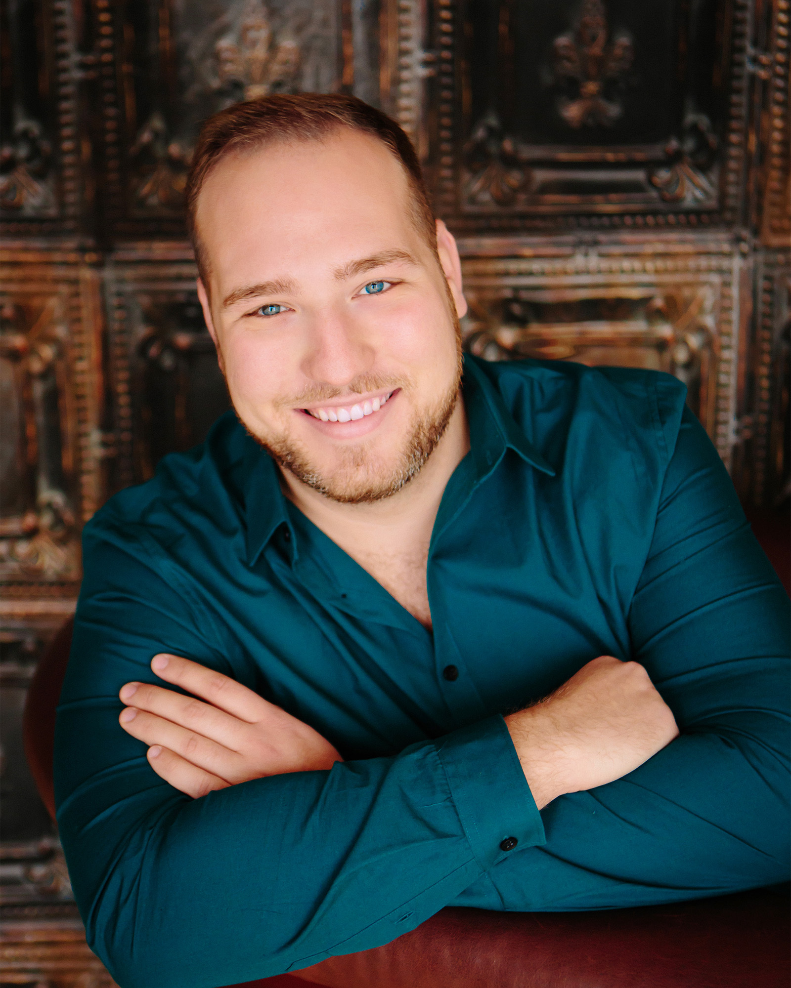 Craig Juricka wearing a teal shirt with arms crossed