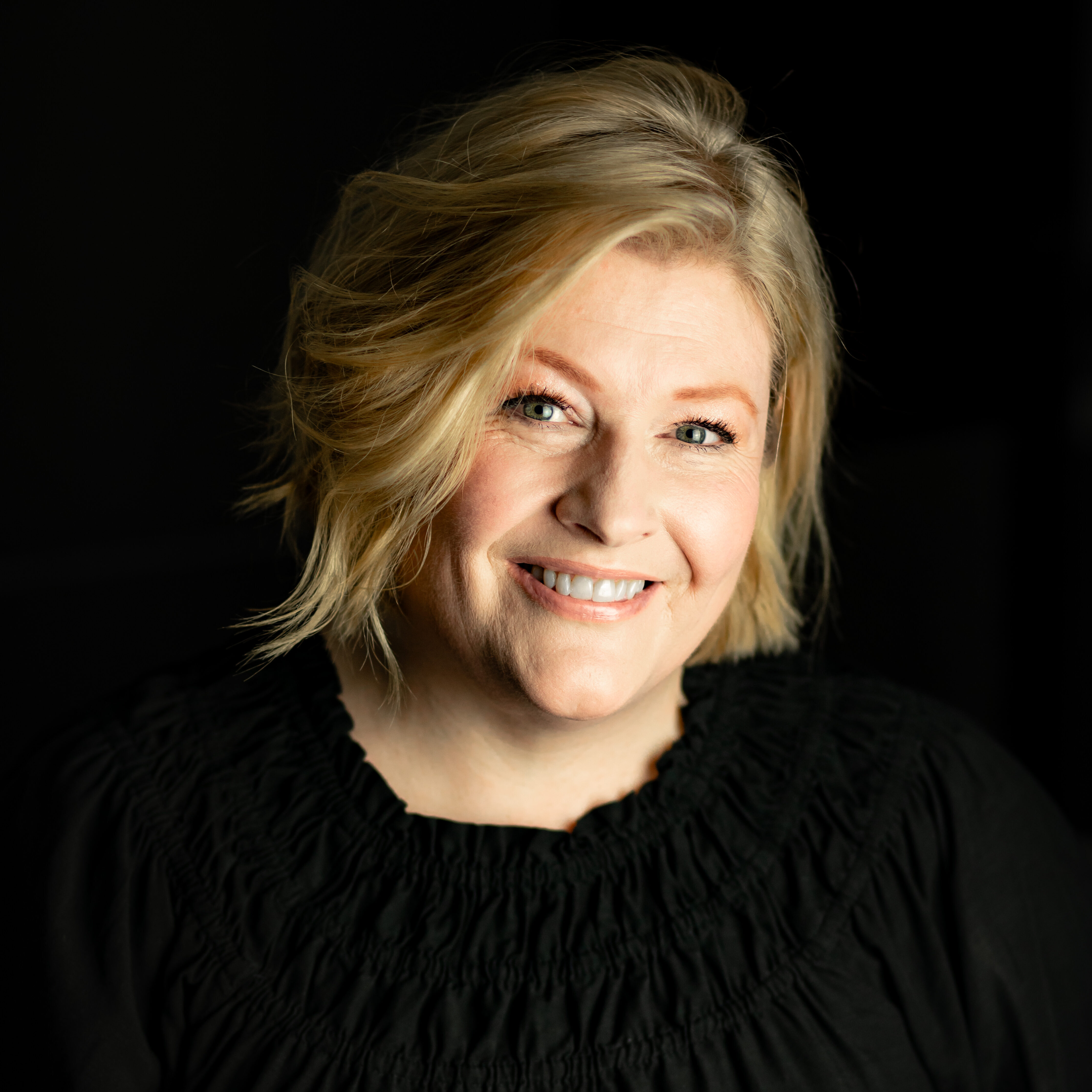 A headshot of Karen Cargill smiling at the camera, wearing a black blouse