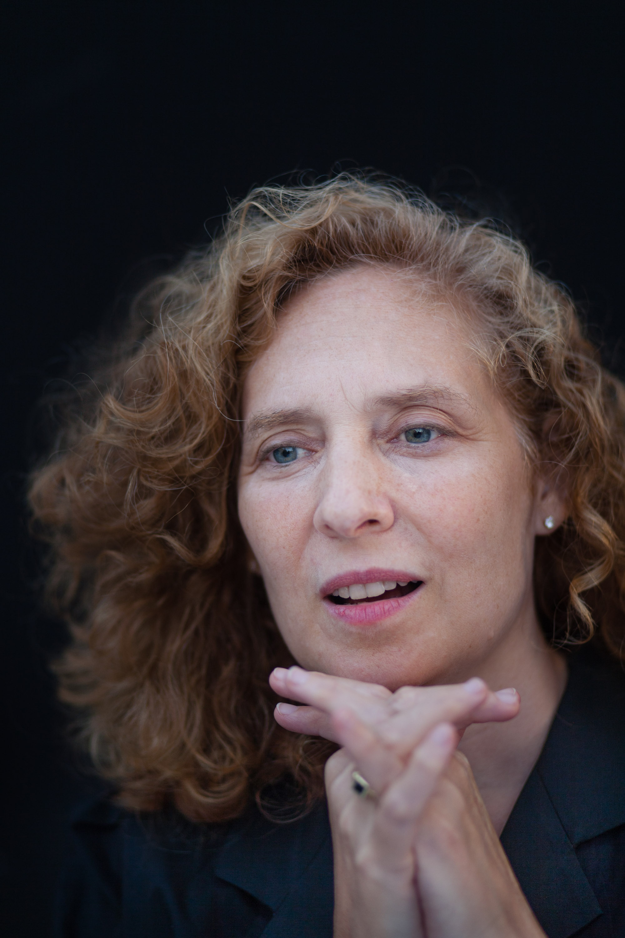 Julia Wolfe sitting with her hands under her chin