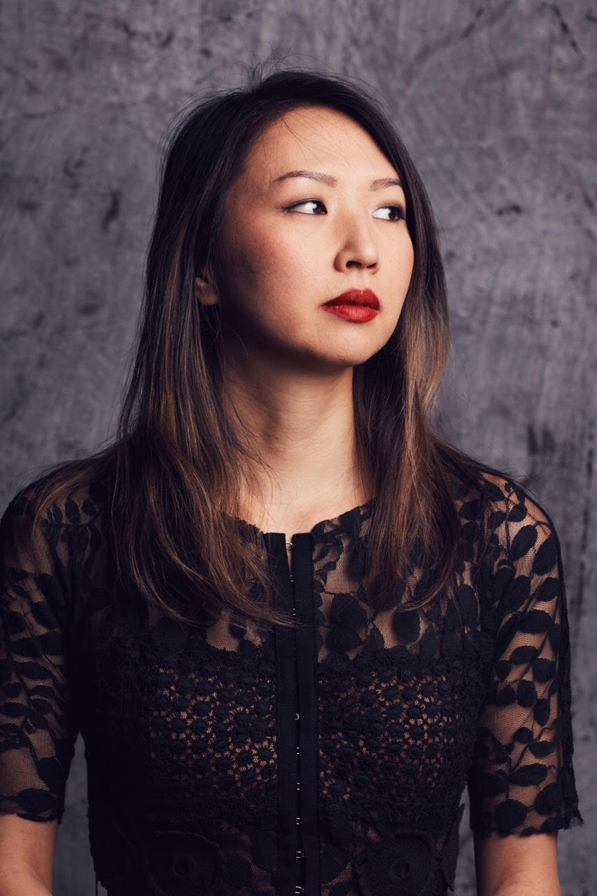 Mario Gotoh looking to our right, wearing a black top