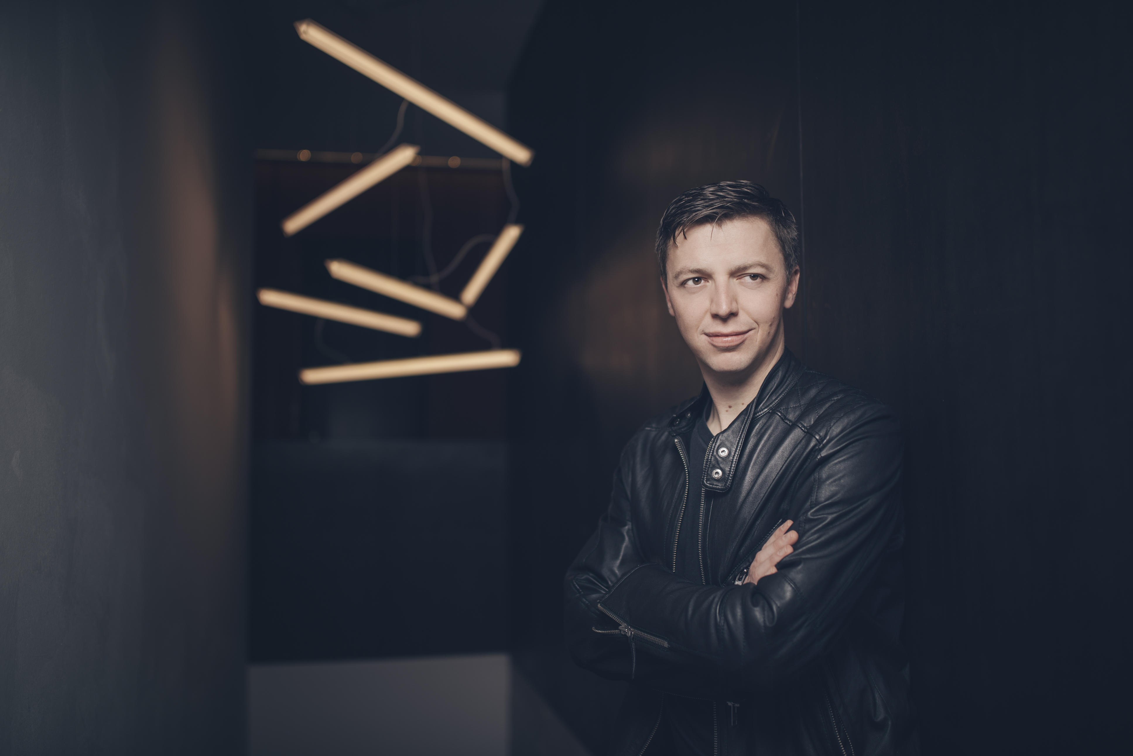 Photo of Martin Grubinger with drumsticks thrown in air in the background