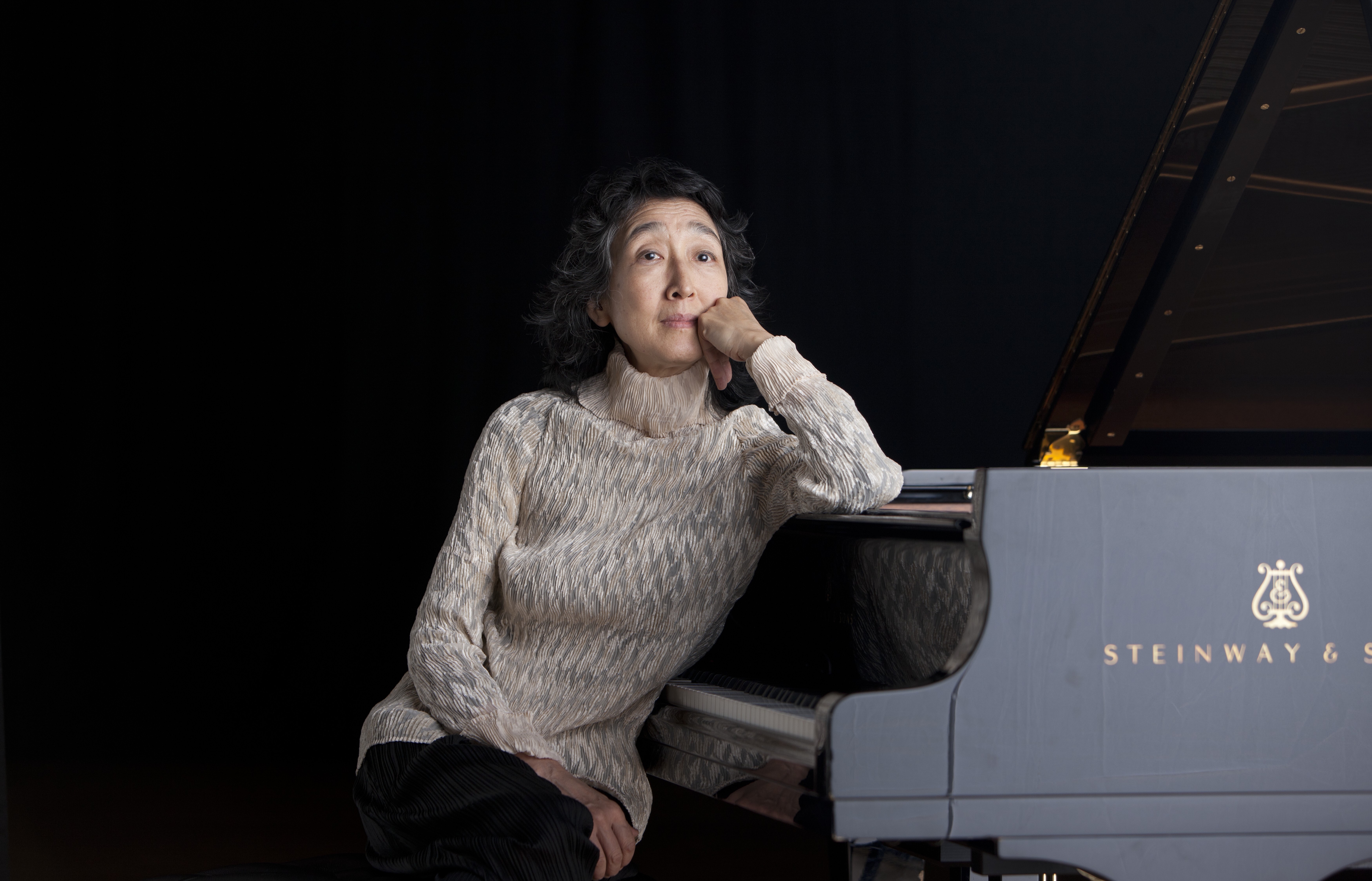 Mitsuko Uchida sitting at a piano